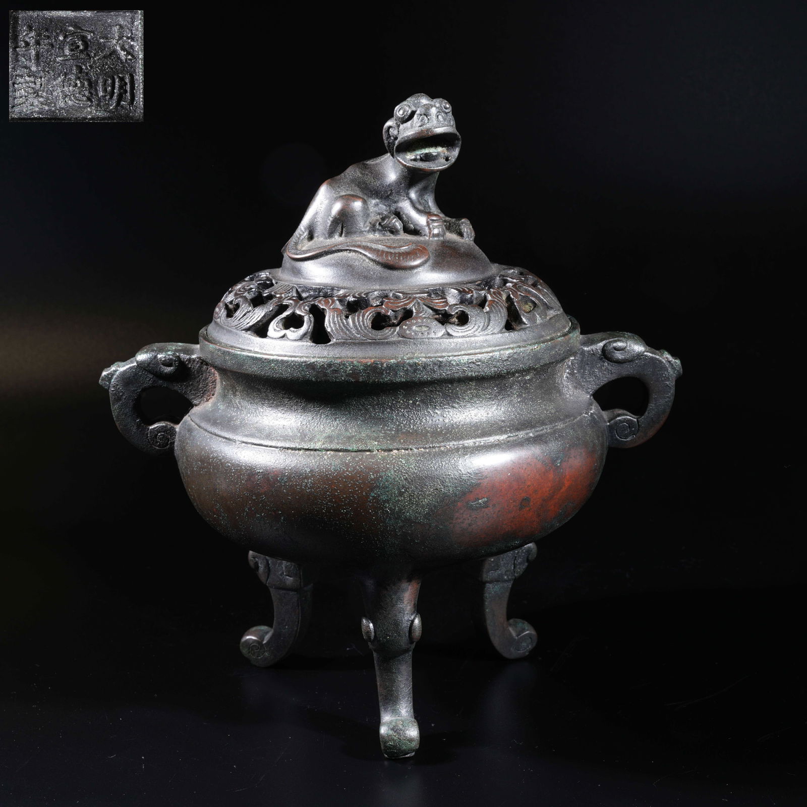 A BRONZE INCENSE BURNER WITH BEAST FINIAL AND TWIN HANDLES: Bronze incense burner with beast finial and twin handles