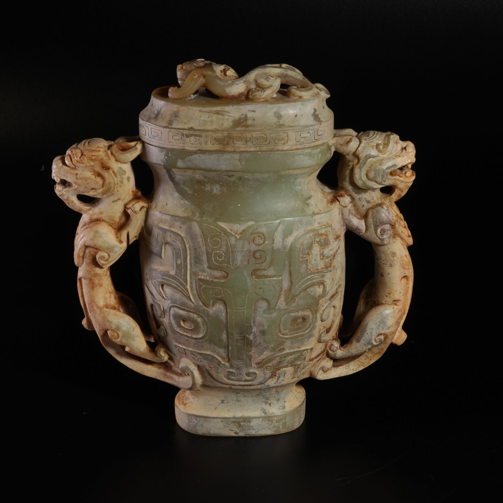 A HETIAN JADE LIDDED VASE WITH DOUBLE DRAGON-SHAPED HANDLES: Hetian jade lidded vase with double dragon-shaped handles