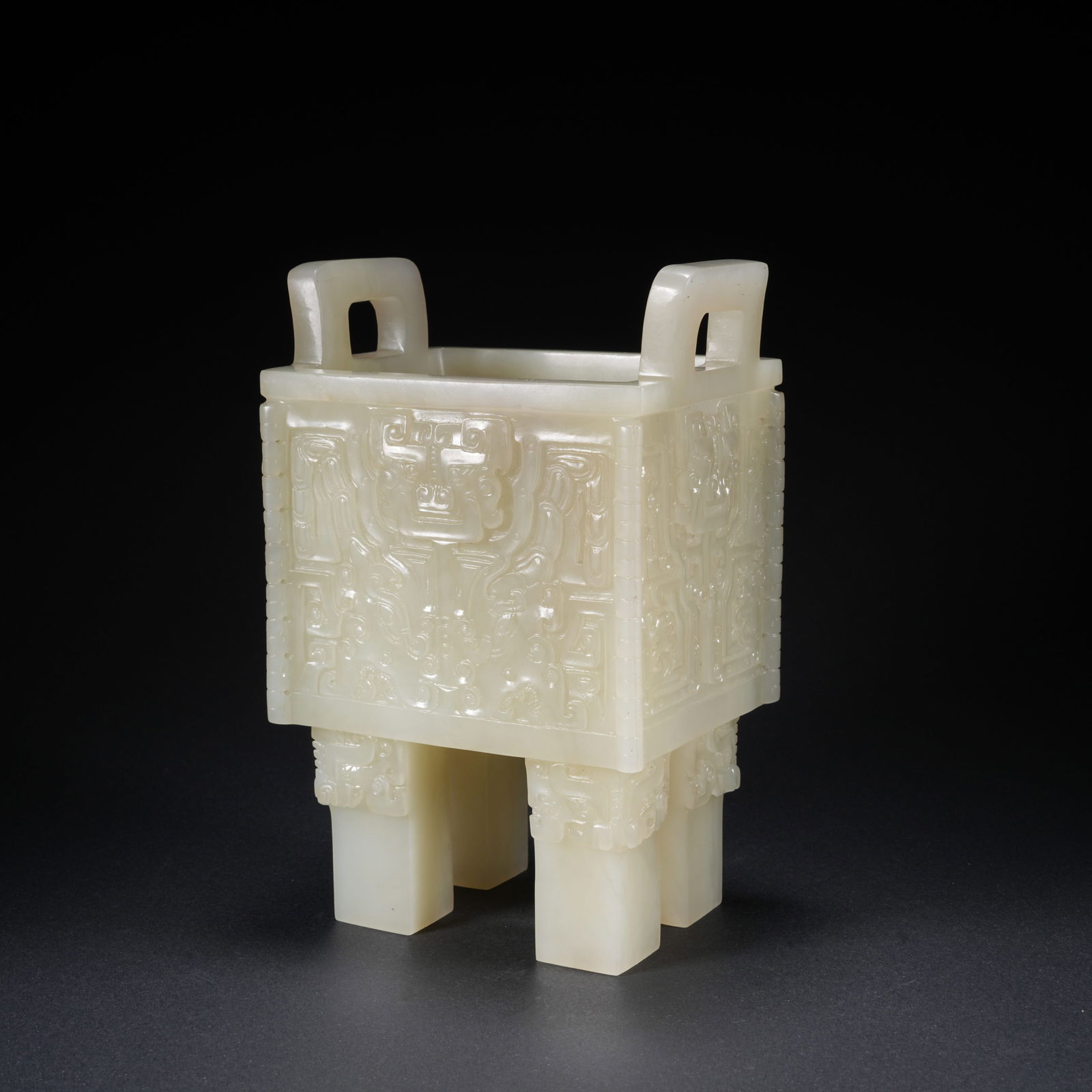 A HETIAN JADE CARVED FOUR-FOOT DING WITH UPRIGHT HANDLES: Hetian Jade Carved Four-Foot Ding with Upright Handles
