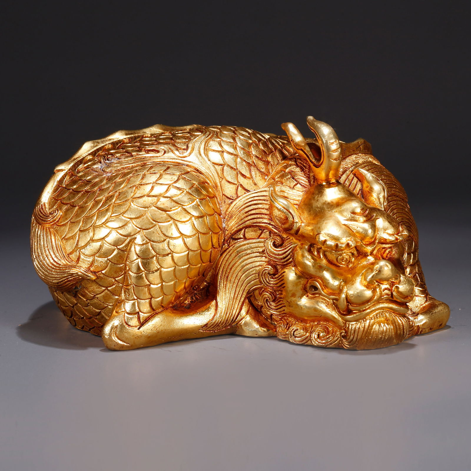 A GILT BRONZE AUSPICIOUS BEAST-SHAPED ORNAMENT (1 of 10)