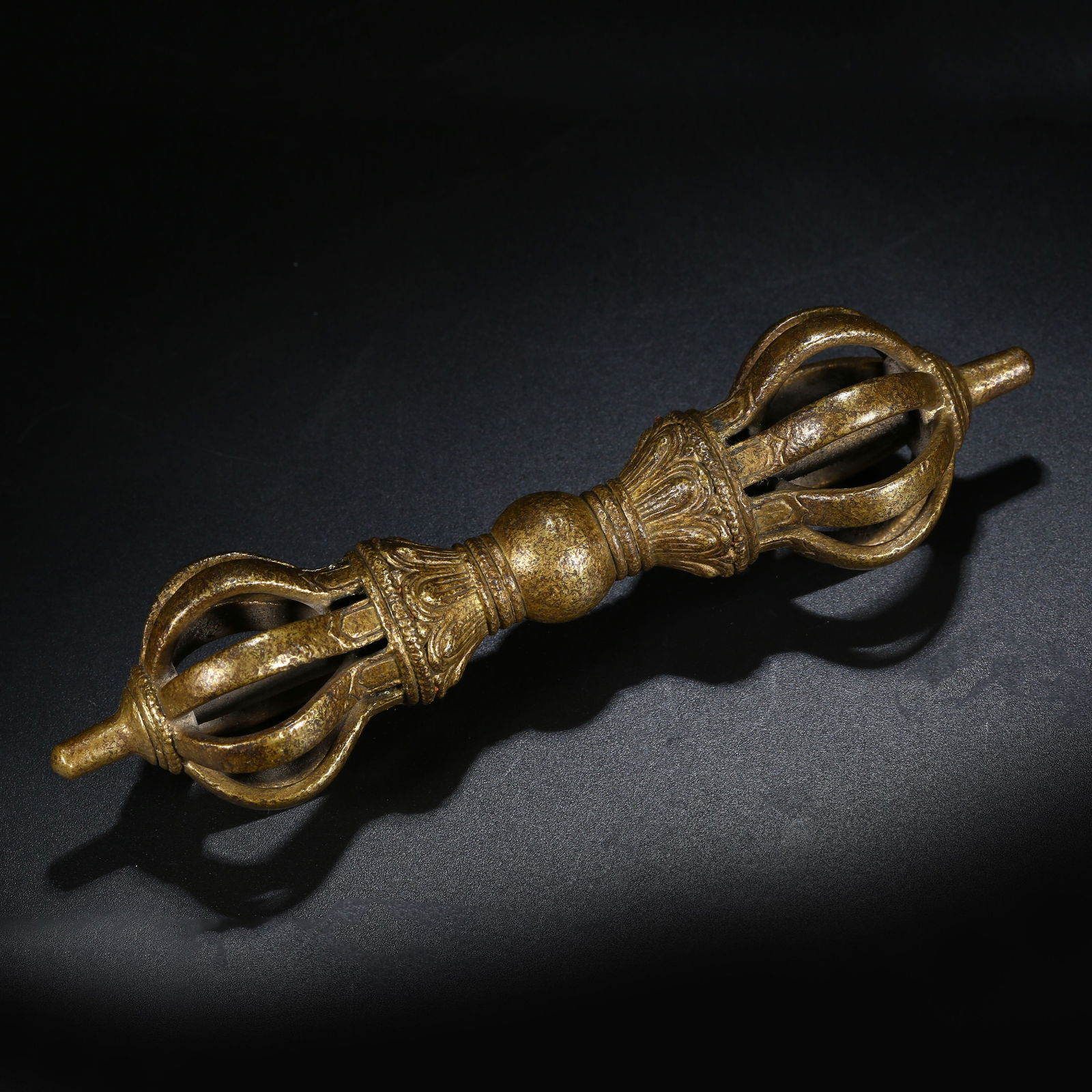 A BRONZE NINE-PRONGED VAJRA RITUAL IMPLEMENT: Bronze nine-pronged vajra ritual implement