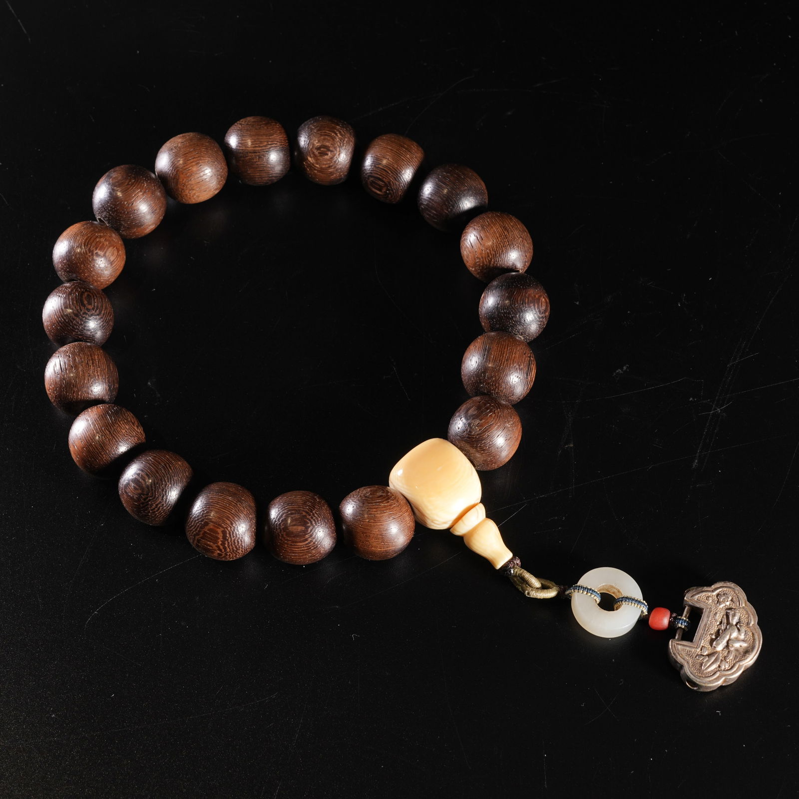 A ZITAN WOOD CARVED BEAD BRACELET: Zitan wood carved bead bracelet
