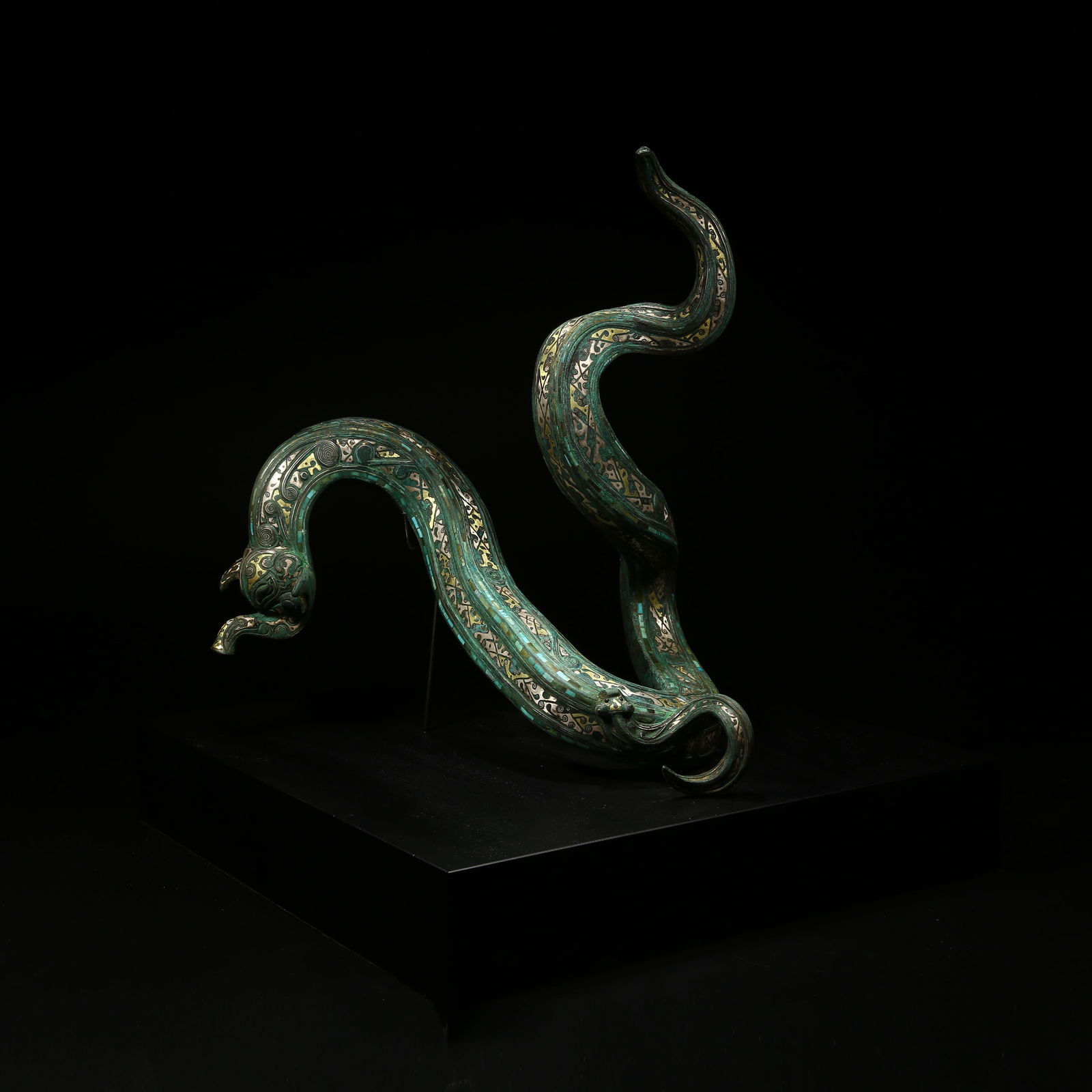 A BRONZE MYTHICAL BEAST ORNAMENT INLAID WITH GOLD AND SILVER: Bronze mythical beast ornament inlaid with gold and silver