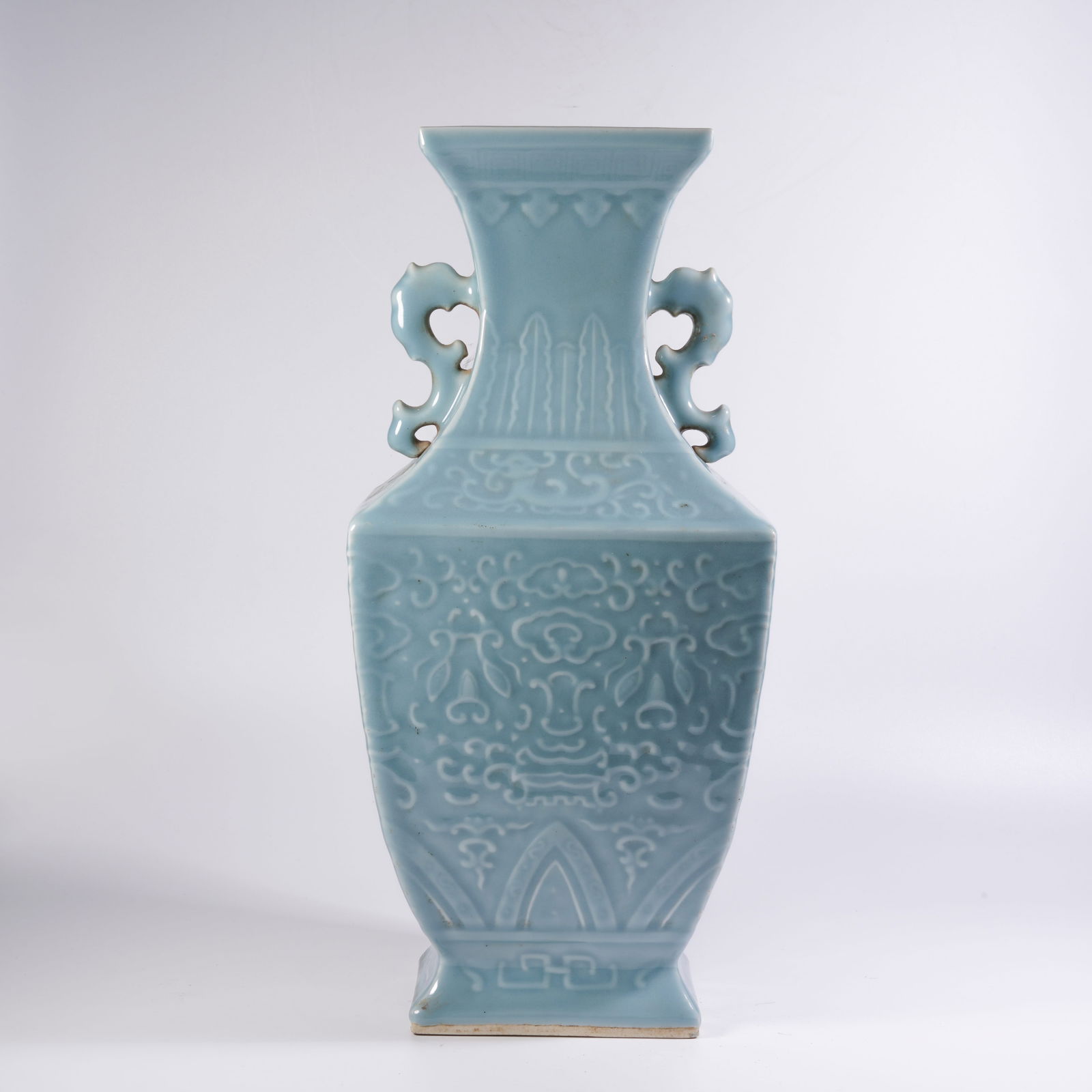 A SKY-BLUE GLAZED DRAGON-HANDLED VASE WITH FLORAL MOTIFS: Sky-blue glazed dragon-handled vase with floral motifs