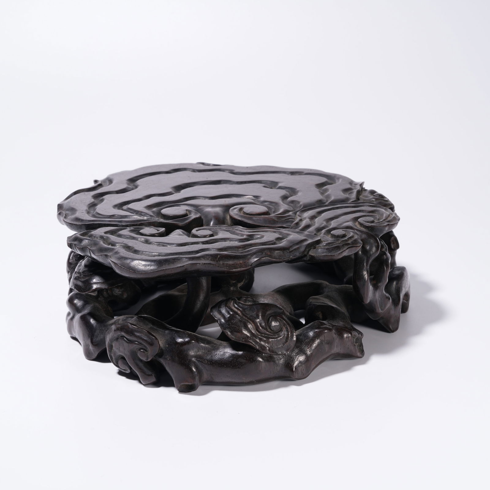 A ZITAN WOOD CARVING LINGZHI-PATTERN BASE: Zitan Wood Carving Lingzhi-Pattern Base