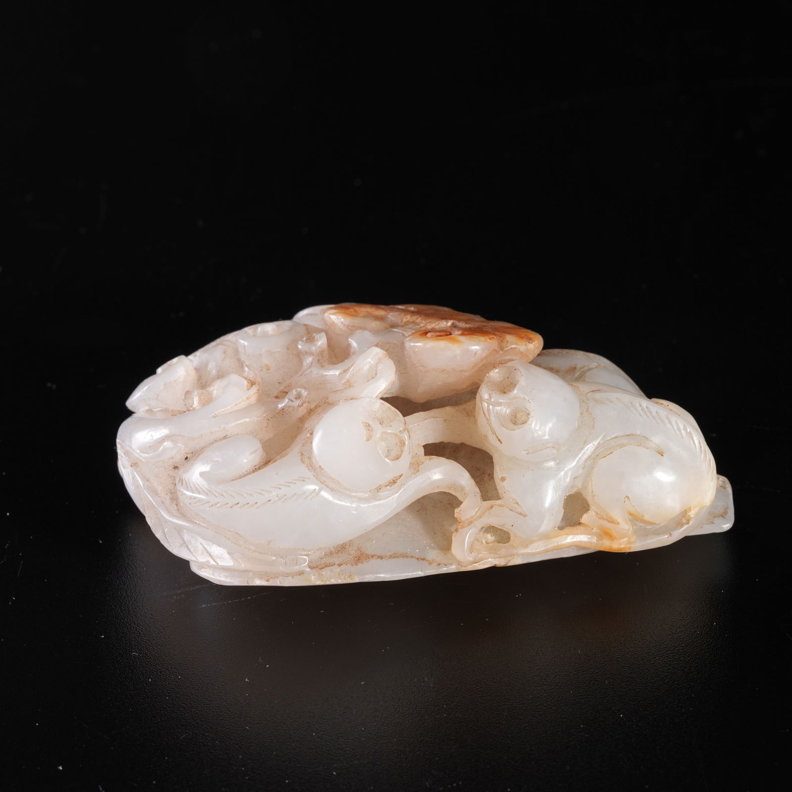 A HETIAN JADE CARVING OF A MONKEY PRESENTING LONGEVITY (DISPLAY PIECE): Hetian jade carving of a monkey presenting longevity (display piece)