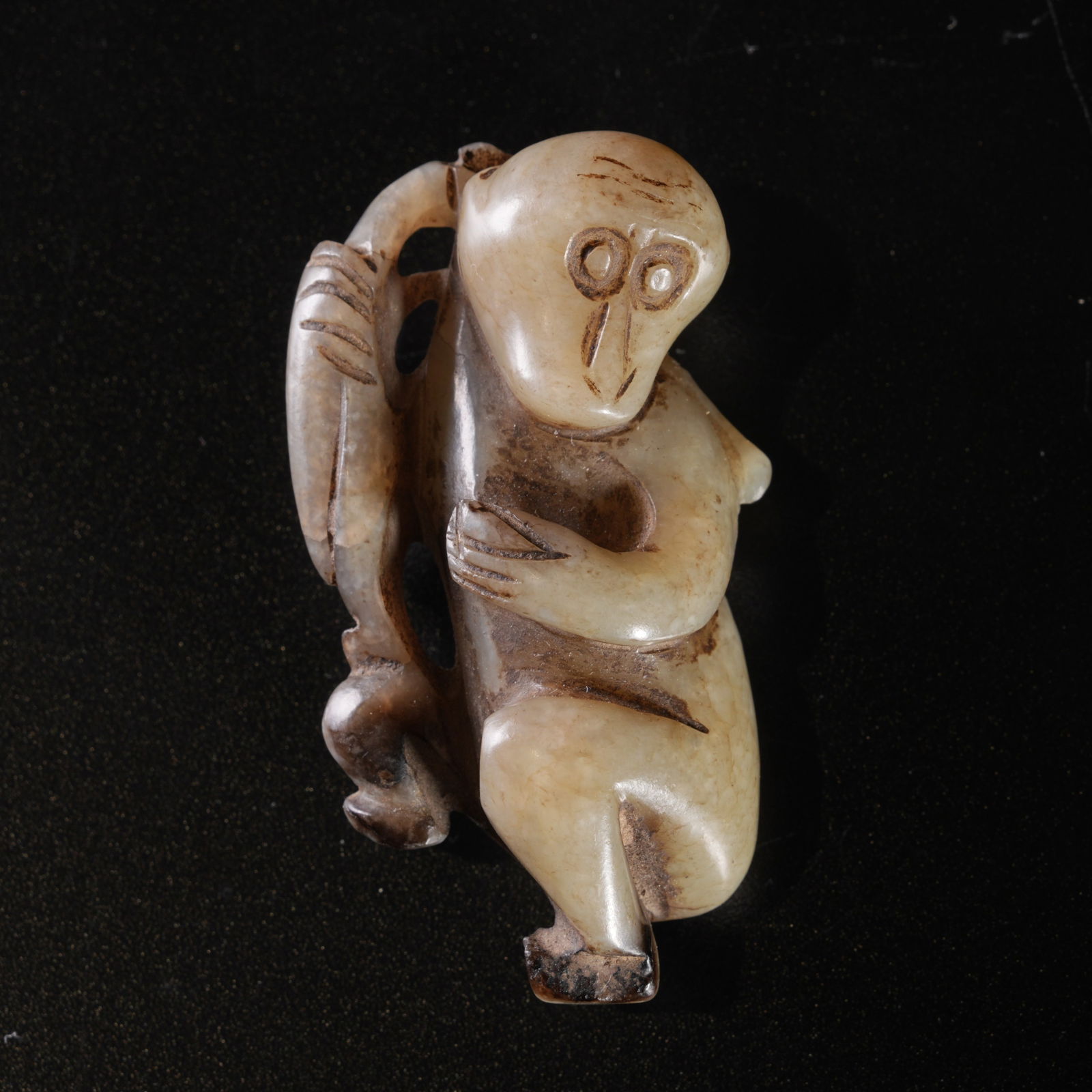 A HETIAN JADE CARVED MONKEY-FORM DISPLAY PIECE: Hetian jade carved monkey-form display piece