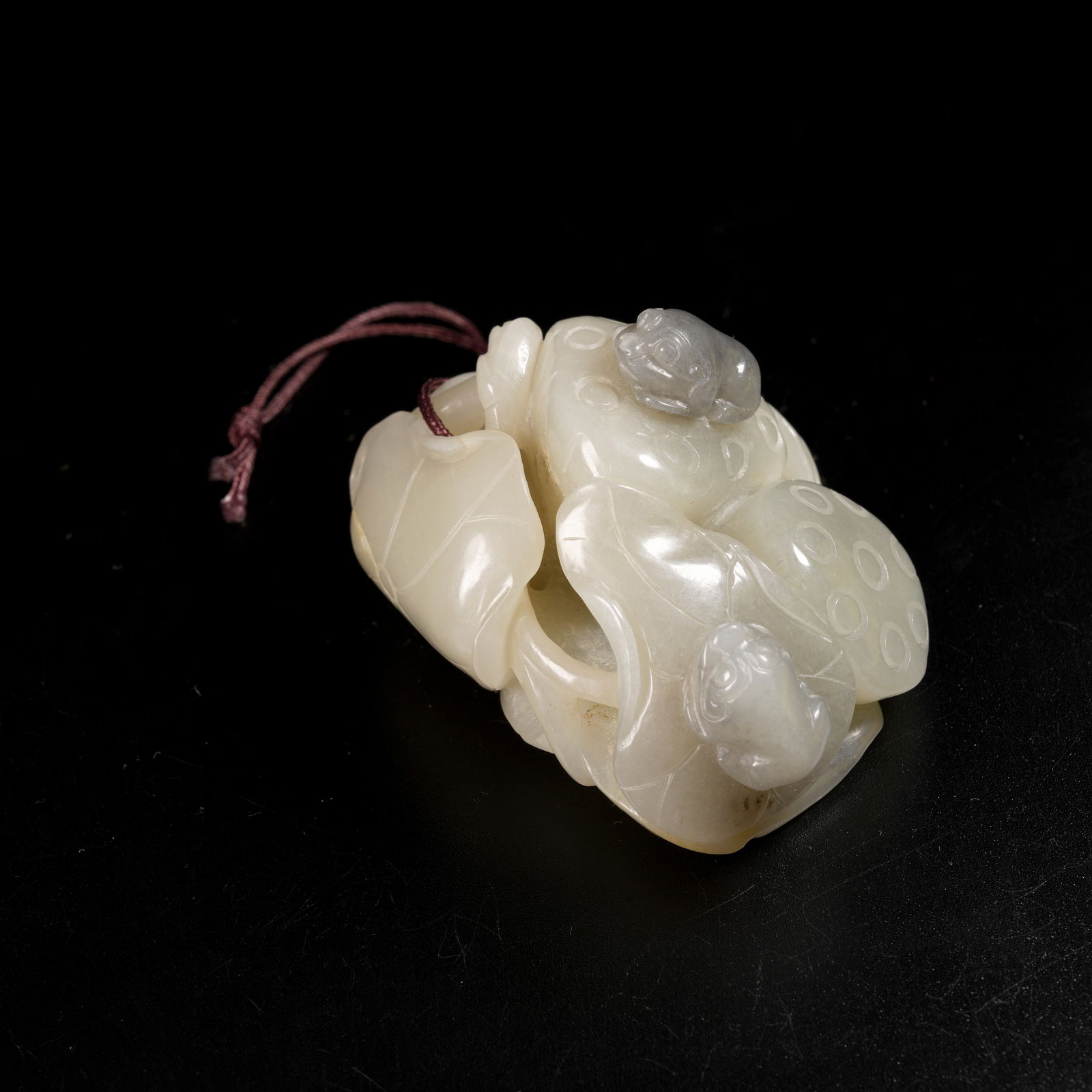 A HETIAN JADE CLEVERLY CARVED "TOAD BRINGS WEALTH" PENDANT (1 of 9)