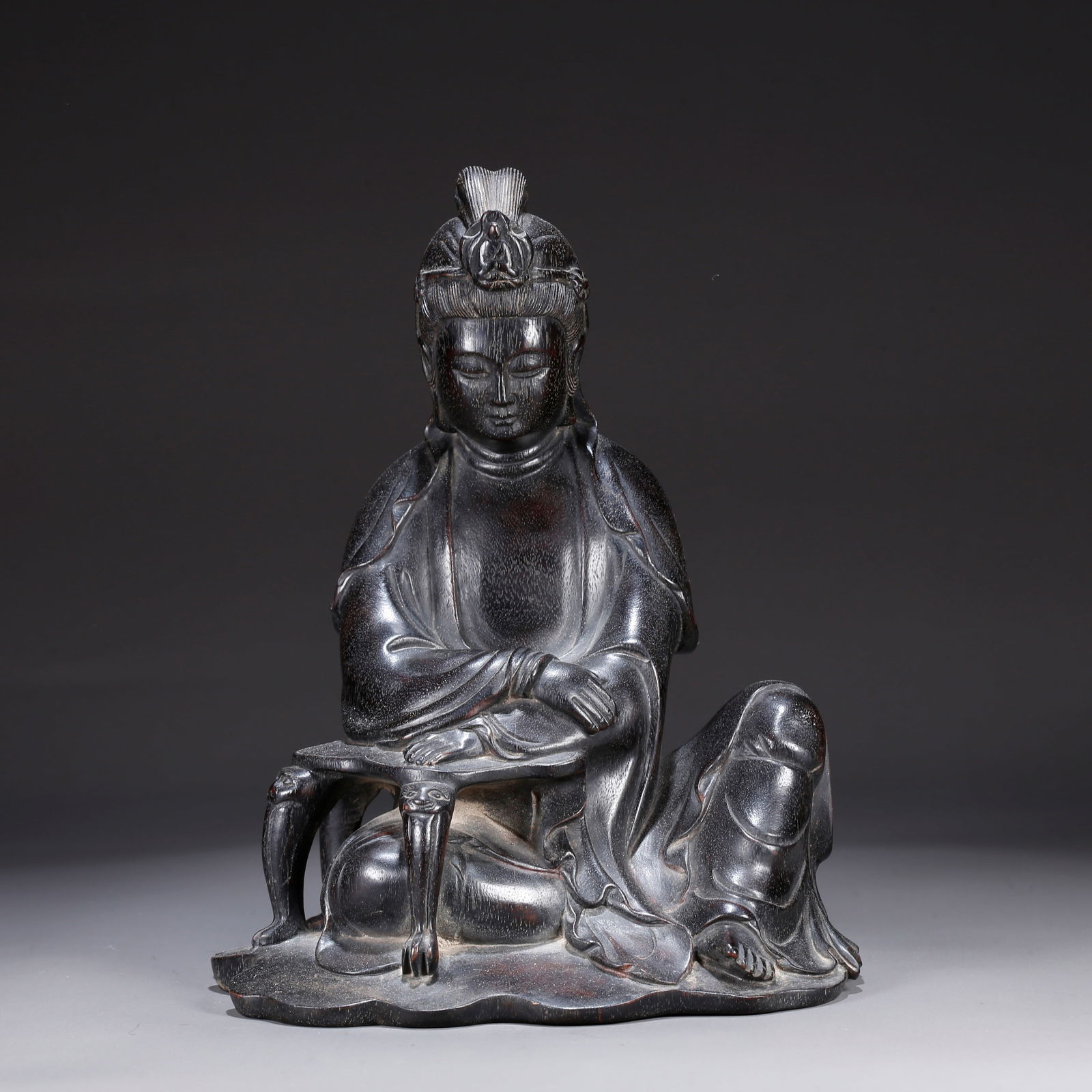 A ZITAN WOOD CARVING OF A SEATED GUANYIN: Zitan wood carving of a seated Guanyin