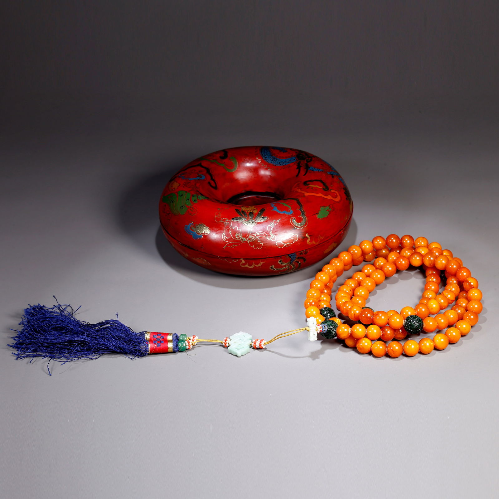 A AMBER CARVING OF HAND HOLDING A FISH: Amber carving of hand holding a fish