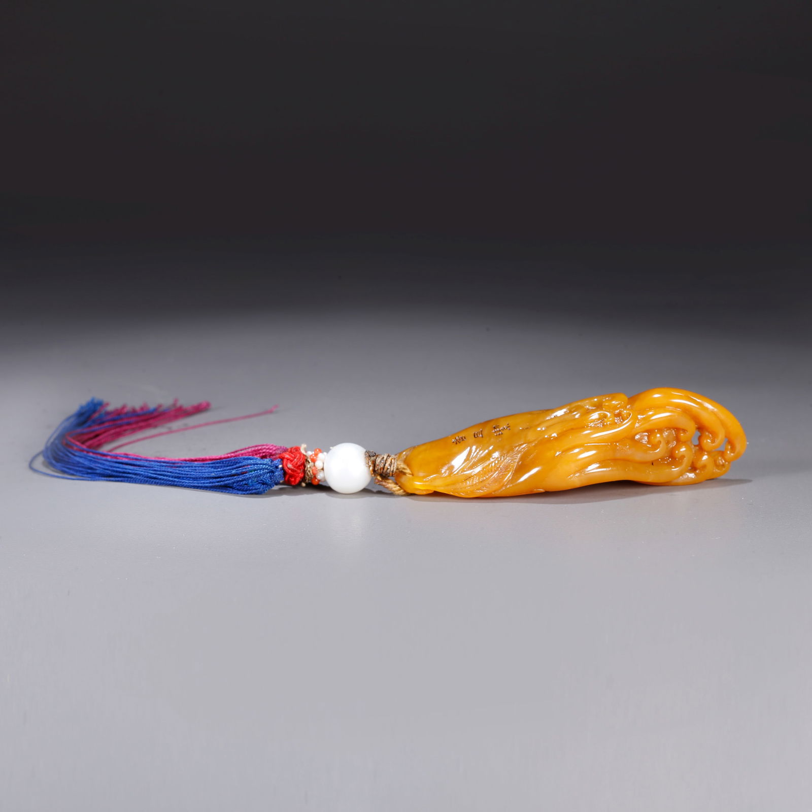 A SHOUSHAN TIANHUANG STONE PENDANT CARVED IN BUDDHA’S HAND FRUIT FORM: Shoushan Tianhuang stone pendant carved in Buddha’s hand fruit form