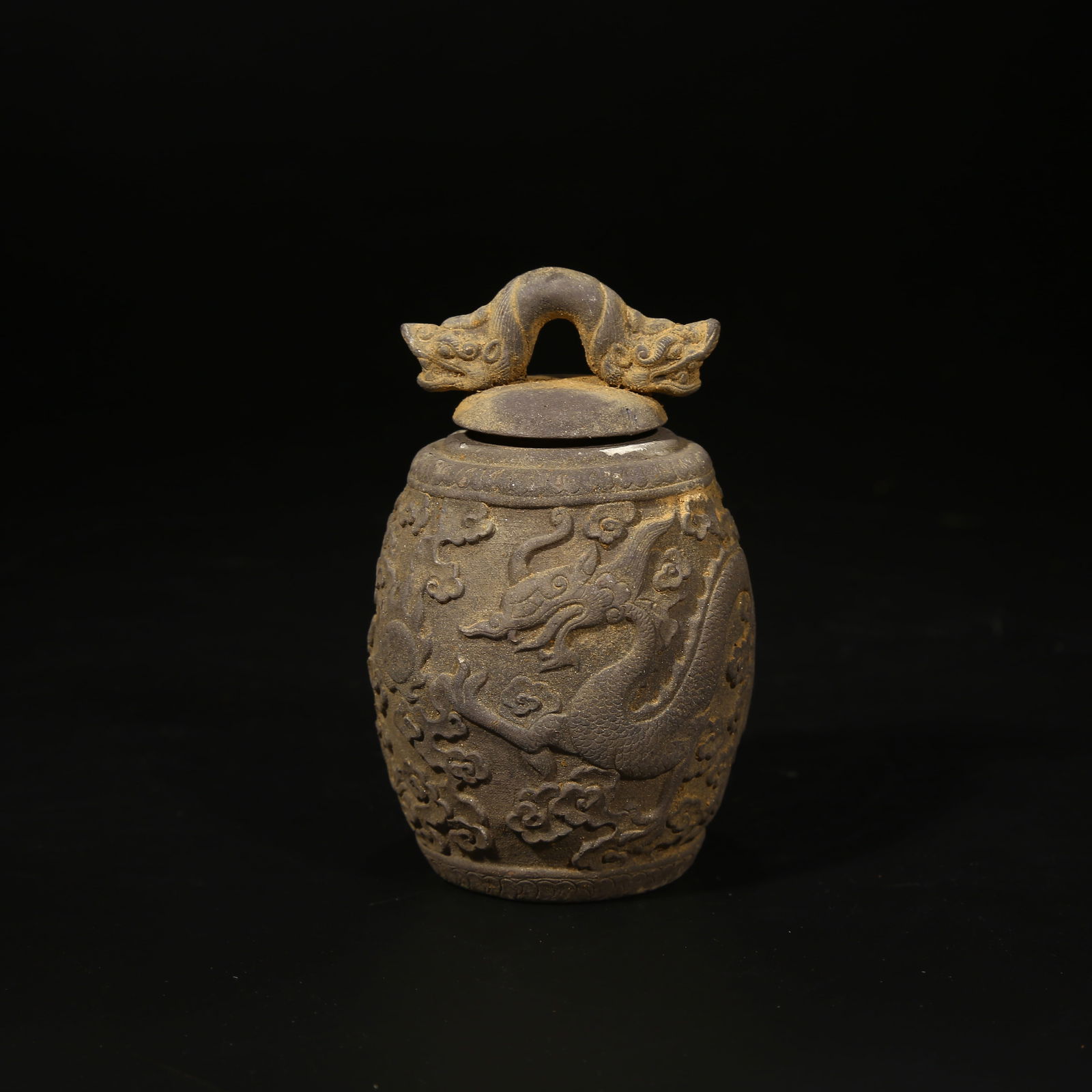 A SILVER SMALL JAR WITH CLOUD AND DRAGON PATTERN: Silver small jar with cloud and dragon pattern