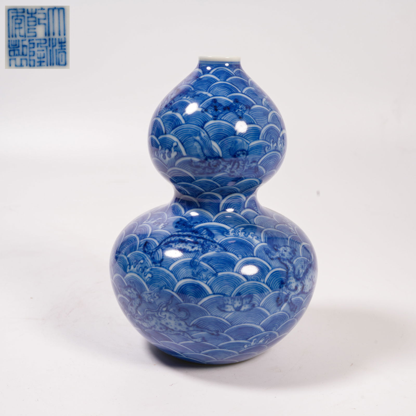 A BLUE-AND-WHITE GOURD-SHAPED VASE WITH SEA DRAGON DESIGN: Blue-and-White Gourd-Shaped Vase with Sea Dragon Design
