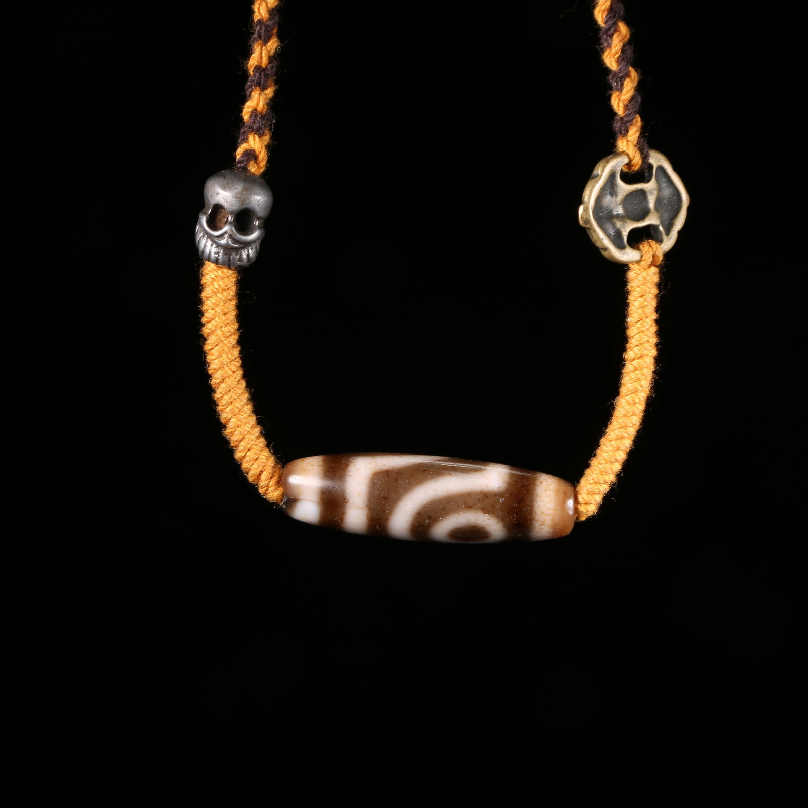 A AGATE TWO-EYED DZI BEAD: Agate Two-Eyed Dzi Bead