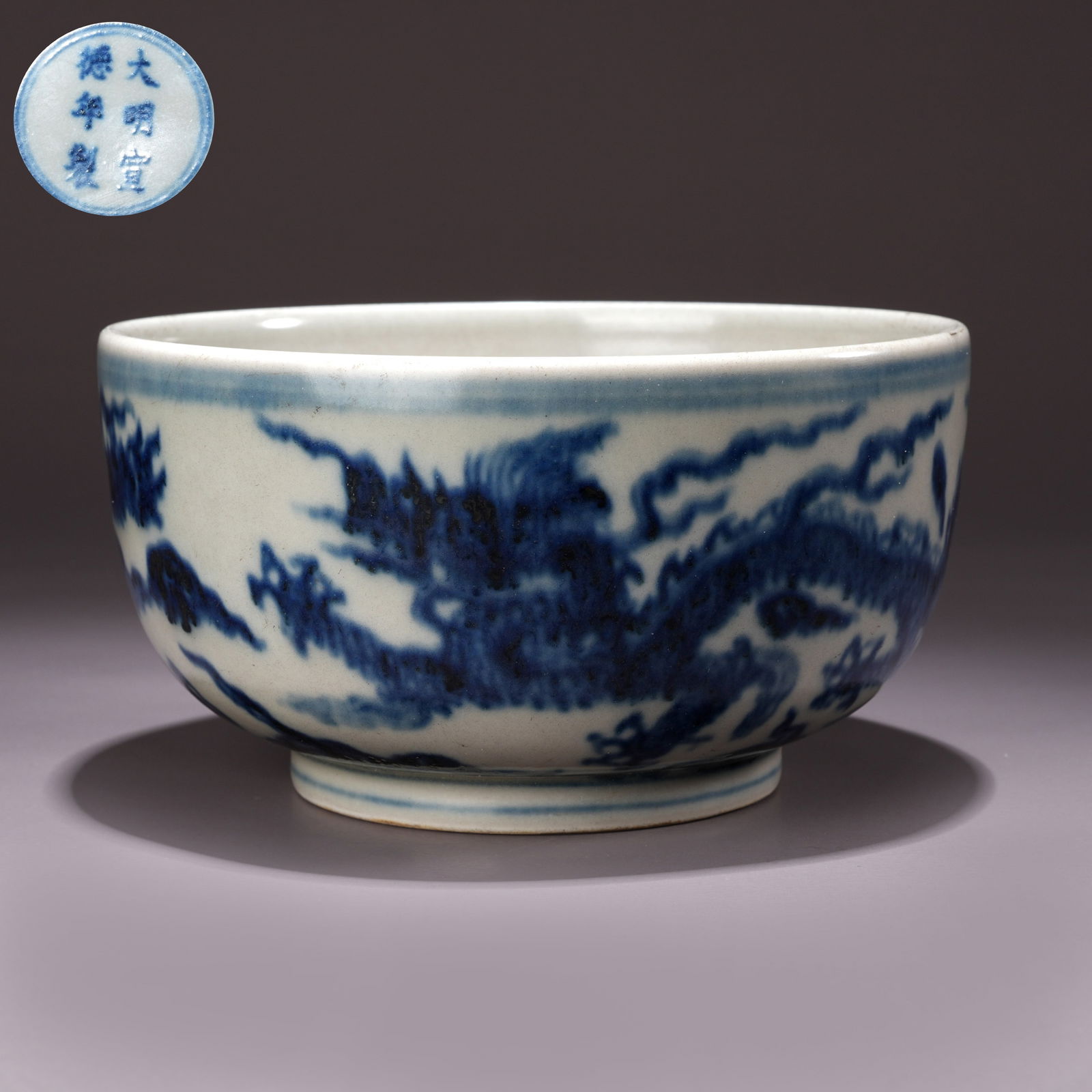 A BLUE-AND-WHITE BOWL WITH CLOUD AND DRAGON MOTIFS: Blue-and-White Bowl with Cloud and Dragon Motifs