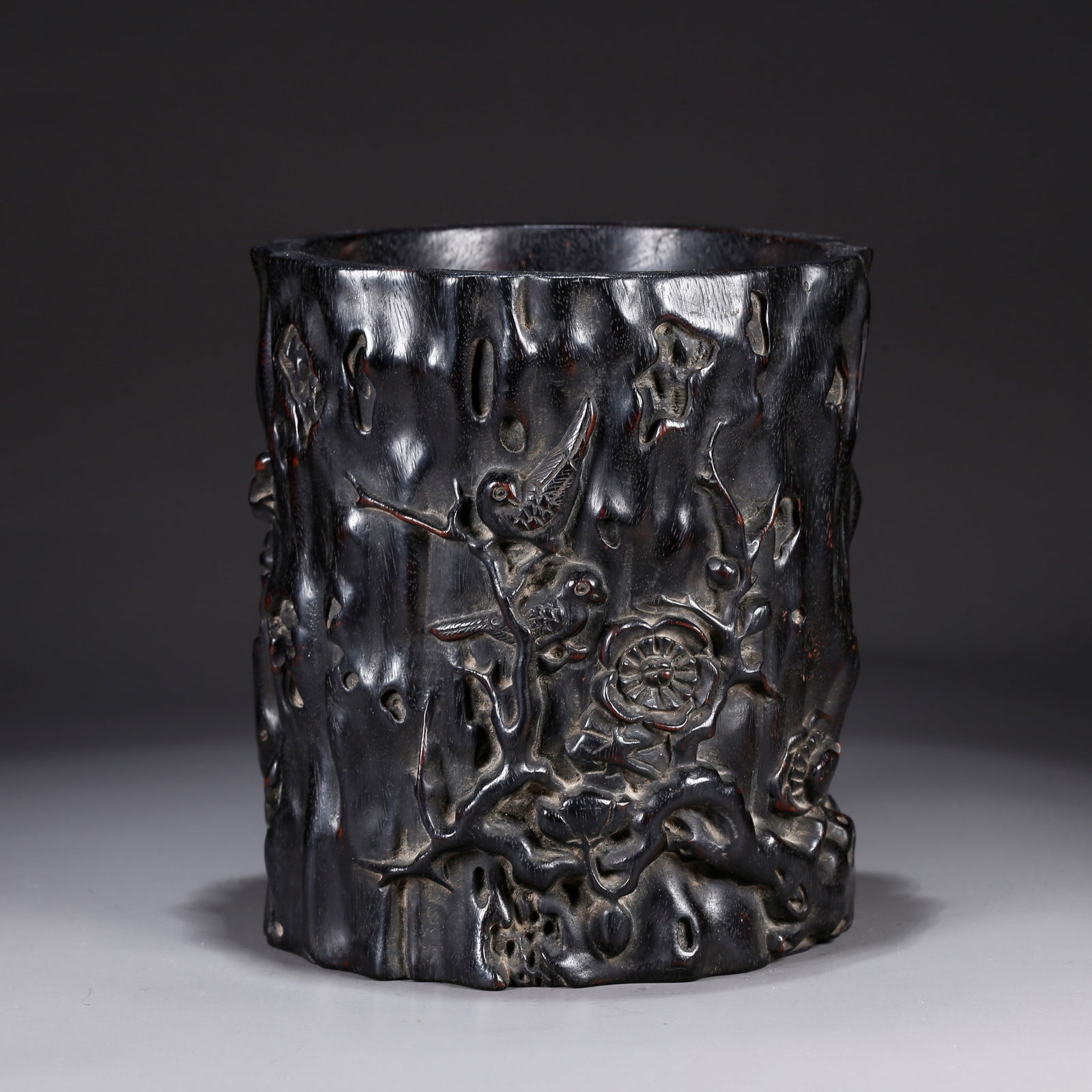 A ZITAN WOOD CARVING OF FLORAL-PATTERNED BRUSH POT: Zitan wood carving of floral-patterned brush pot