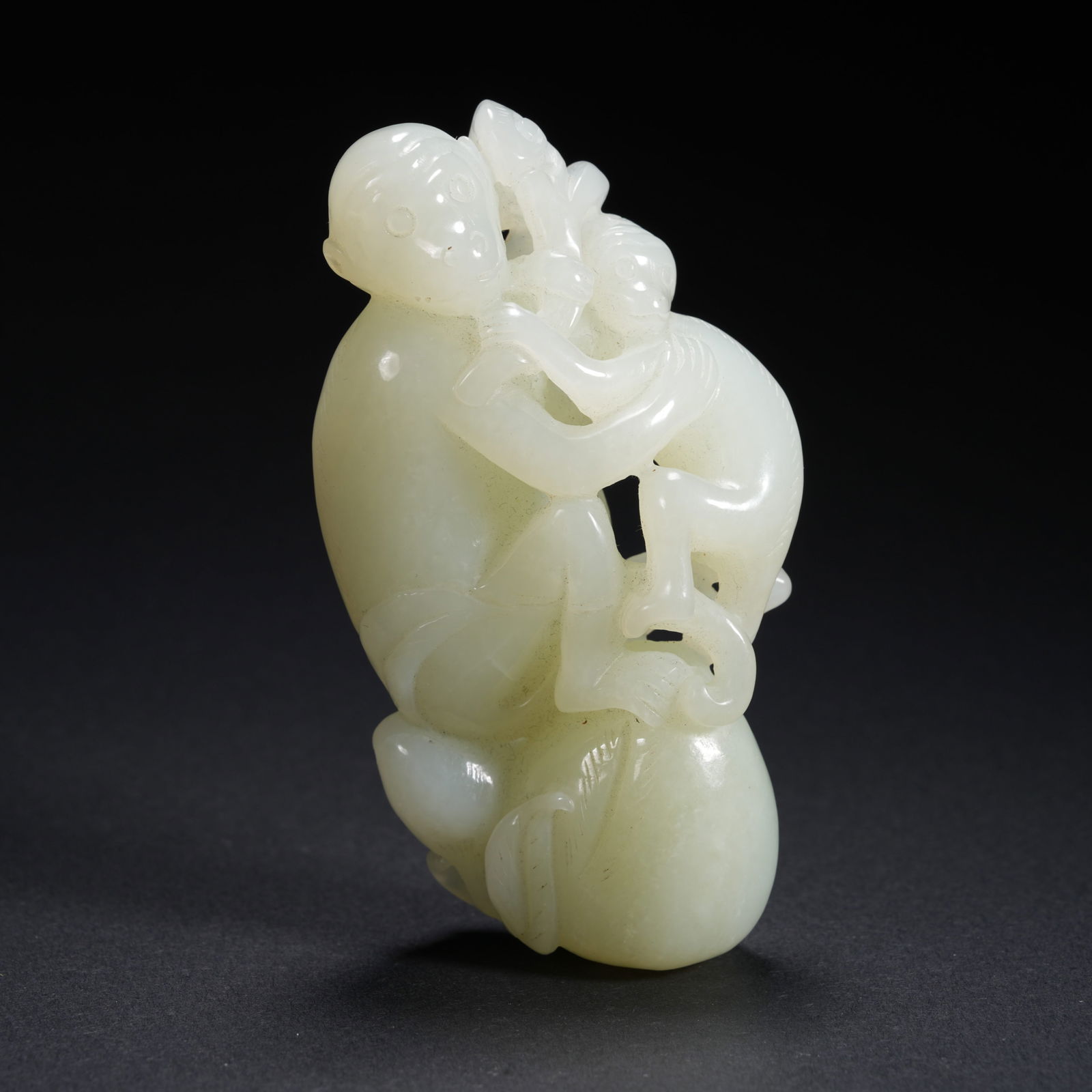 A HETIAN JADE CARVED MOTHER-AND-CHILD MONKEY FIGURE (1 of 10)