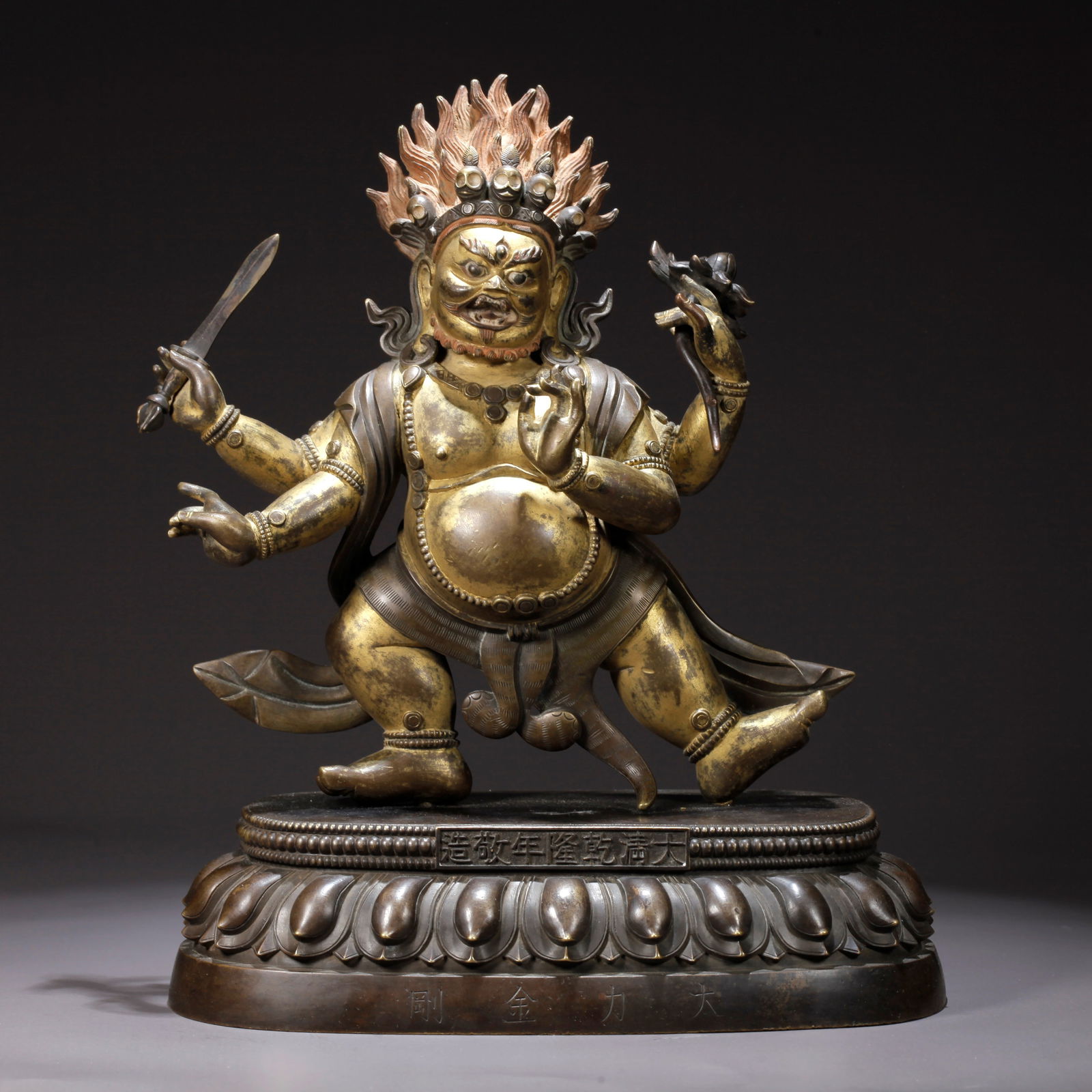A GILDED BRONZE FOUR-ARMED MAHAKALA STATUE: Gilded Bronze Four-Armed Mahakala Statue