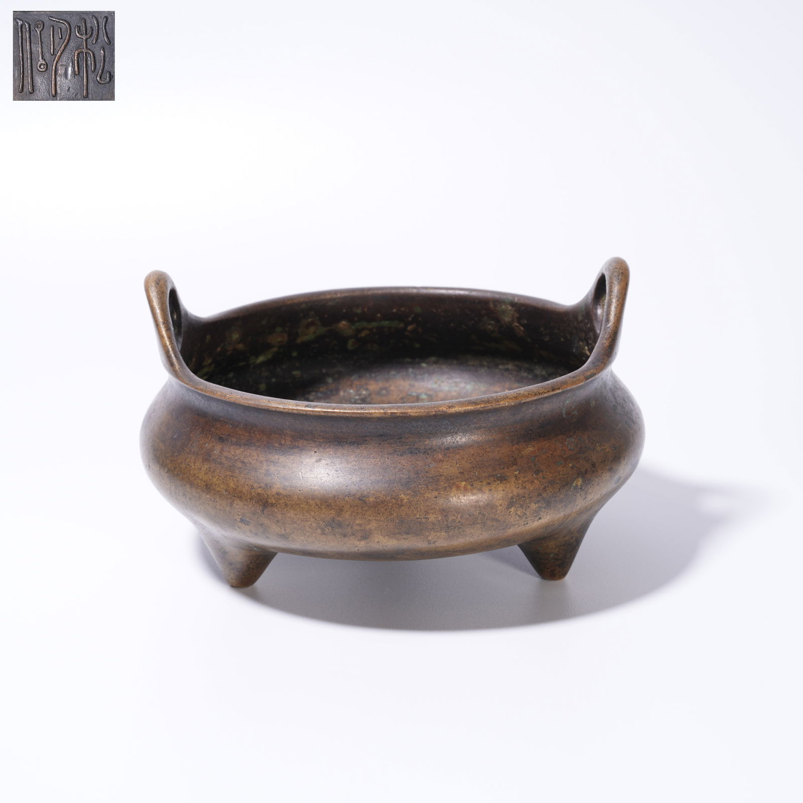 A BRONZE DOUBLE-HANDLED CENSER: Bronze Double-Handled Censer