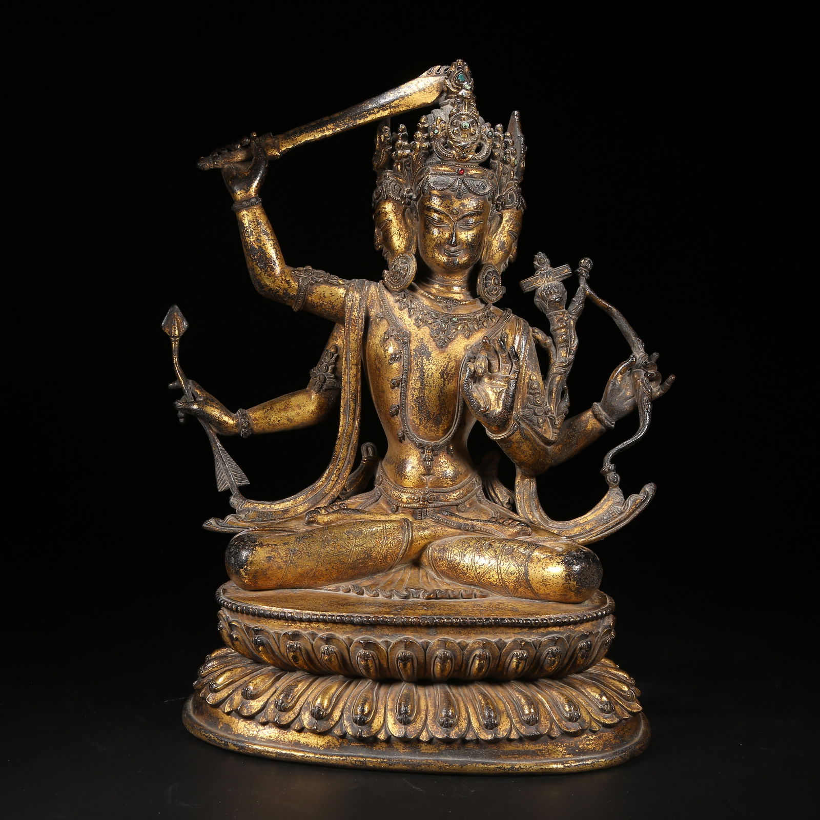 A GILT BRONZE FOUR-ARMED MANJUSHRI STATUE: Gilt Bronze Four-Armed Manjushri Statue