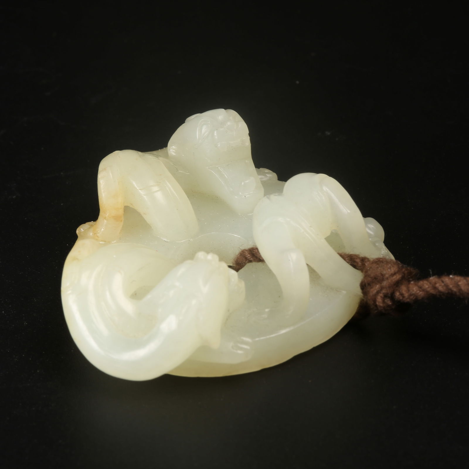 A ARCHAIC JADE BI DISC WITH CHILONG MOTIF AND RAISED BORDER (1 of 8)