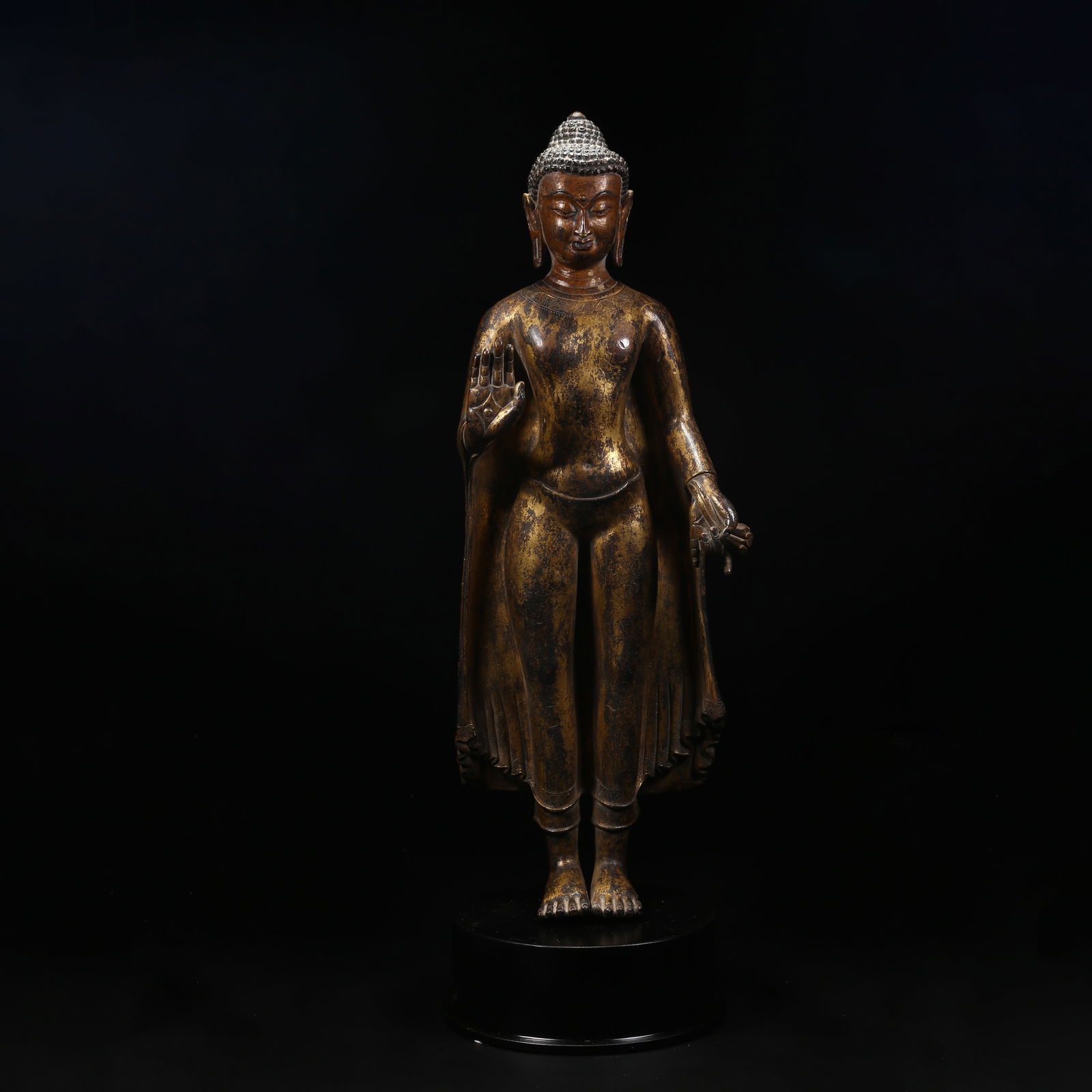 A GILT BRONZE STANDING STATUE OF SHAKYAMUNI: Gilt copper standing statue of Shakyamuni