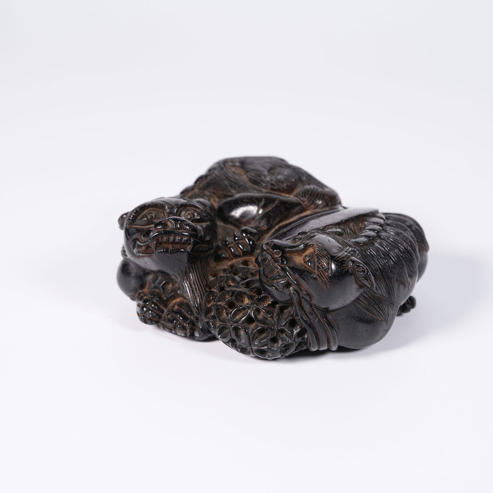 A ZITAN WOOD LION ROLLING BALL ORNAMENT: Zitan Wood Lion Rolling Ball Ornament