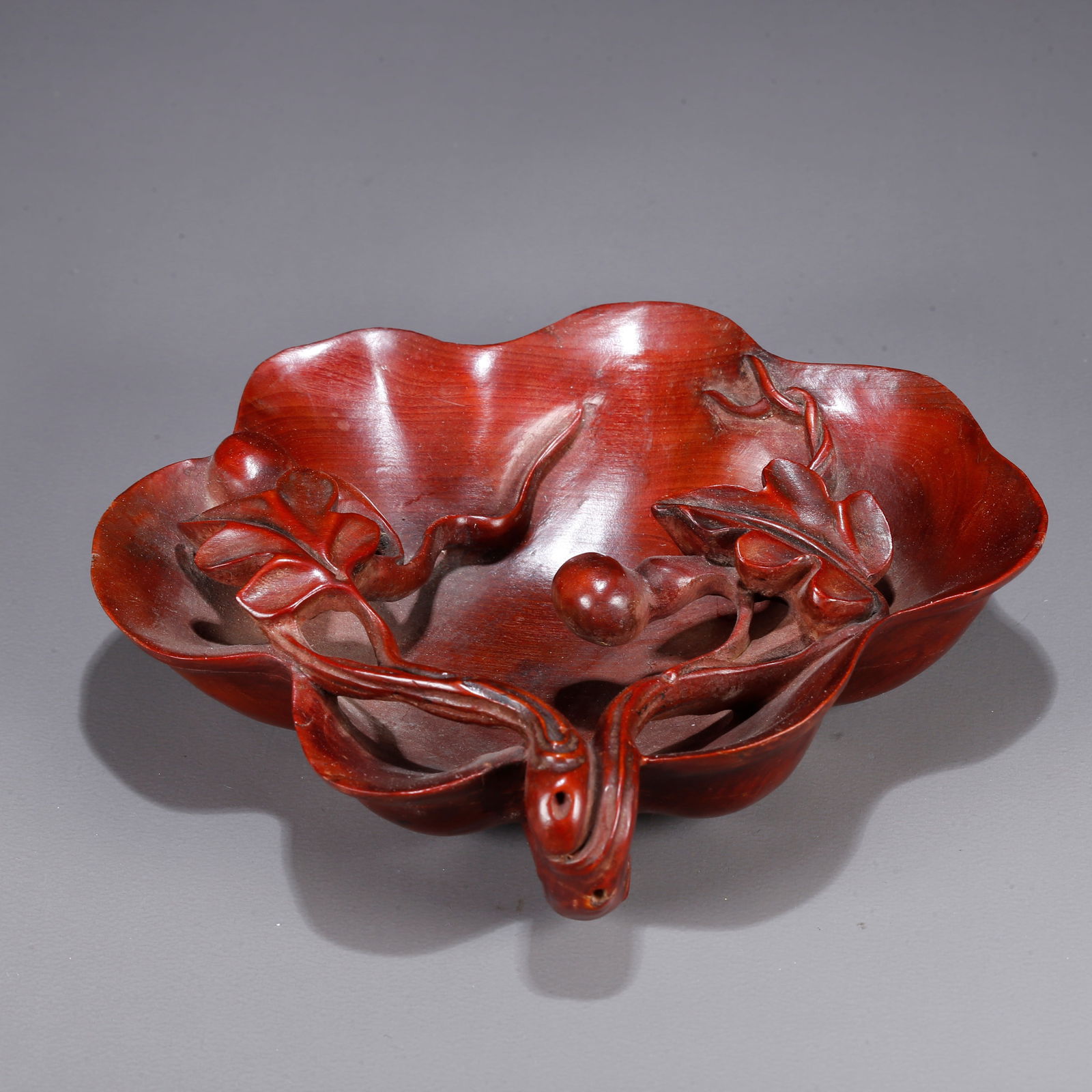 A HUANGHUALI WOOD CARVING OF A GOURD-PATTERNED WATER VESSEL: Huanghuali wood carving of a gourd-patterned water vessel