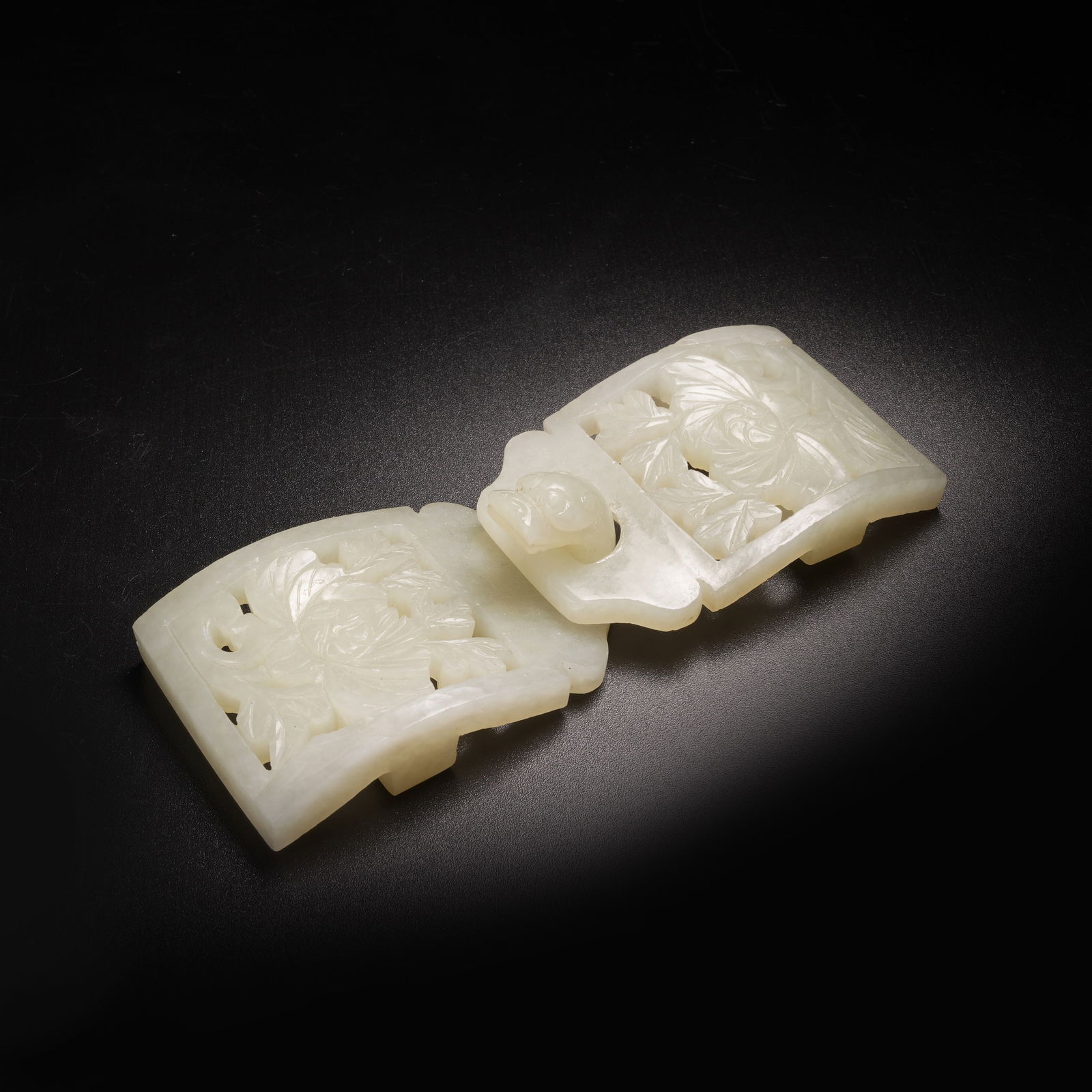 A SET OF HETIAN JADE FLORAL-PATTERNED BELT BUCKLES: Set of Hetian jade floral-patterned belt buckles