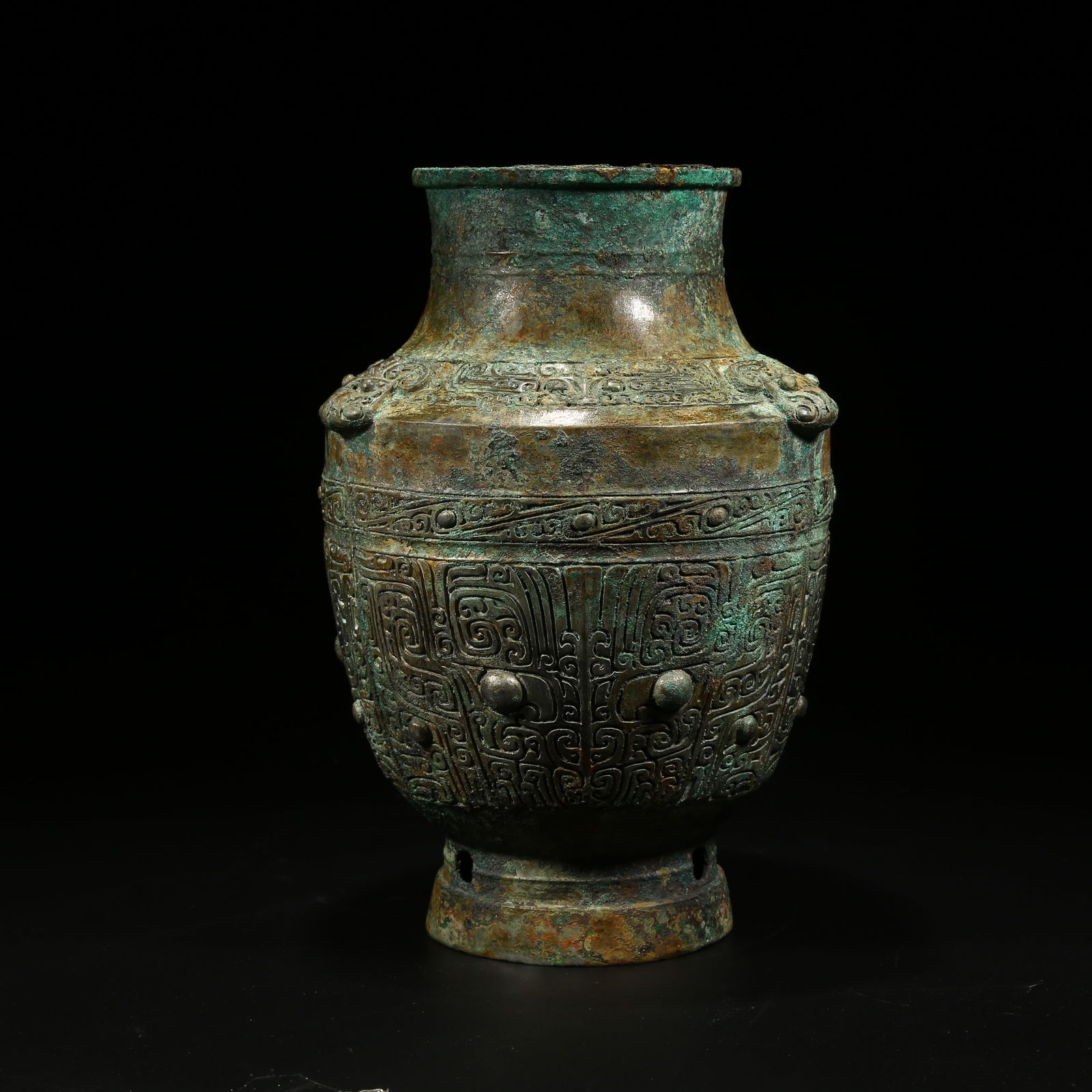 A BRONZE ZUN VESSEL WITH TAOTIE (BEAST FACE) PATTERN: Bronze zun vessel with taotie (beast face) pattern