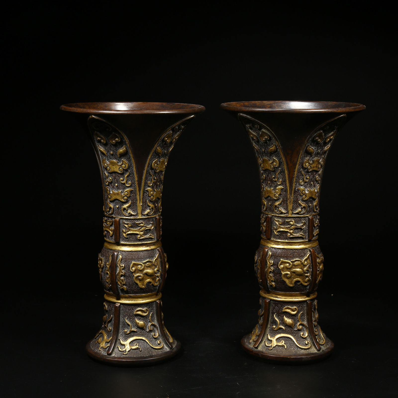 A SET OF BRONZE FLARED VASES WITH BEAST MASK DESIGN AND PARTIAL GILDING: Set of Bronze Flared Vases with Beast Mask Design and Partial Gilding