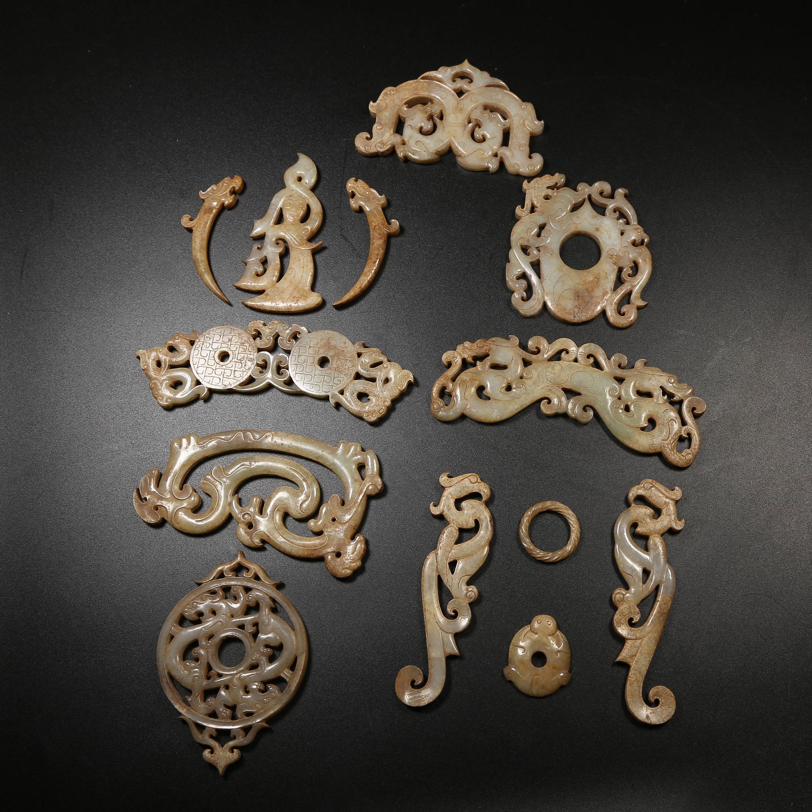 A ANCIENT JADE DANCING FIGURES AND AUSPICIOUS BEAST PENDANT SET: Ancient Jade Dancing Figures and Auspicious Beast Pendant Set