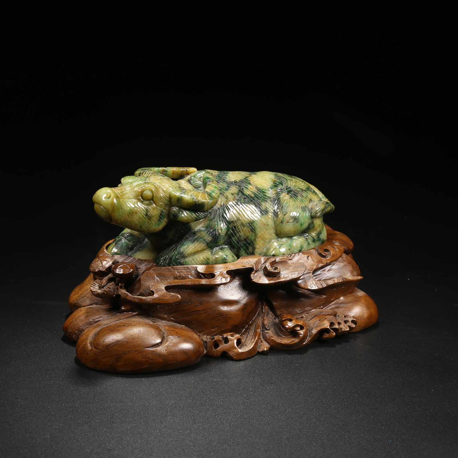 A JADEITE RECLINING OX ORNAMENT: Jadeite Reclining Ox Ornament
