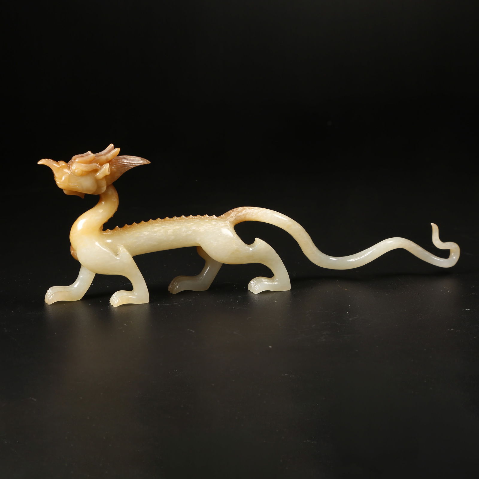 A ARCHAIC JADE DRAGON-IN-MOTION FIGURINE: Archaic Jade Dragon-in-Motion Figurine