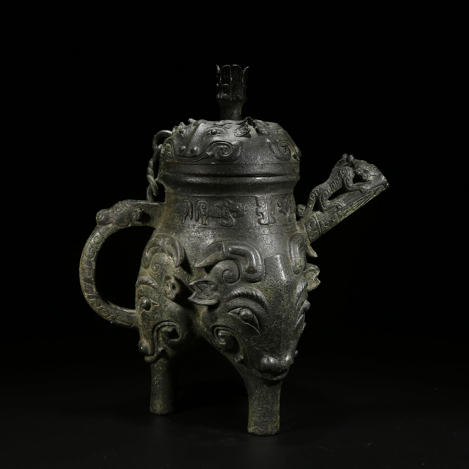 A BRONZE HE VESSEL WITH TAOTIE (BEAST FACE) PATTERN: Bronze he vessel with taotie (beast face) pattern