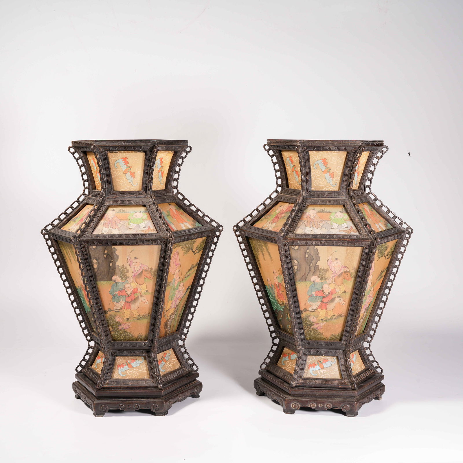 A SET OF PALACE LANTERNS WITH HAND-PAINTED INFANTS AT PLAY ON ZITAN WOOD AND SILK: Set of Palace Lanterns with Hand-Painted Infants at Play on Zitan Wood and Silk