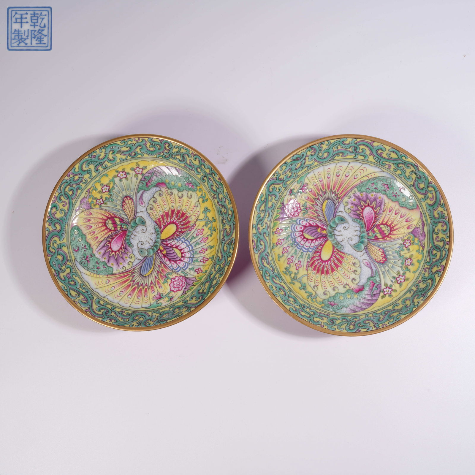 A SET OF ENAMELLED PLATES WITH FLOWER-AND-BUTTERFLY MOTIFS: Set of enamelled plates with flower-and-butterfly motifs