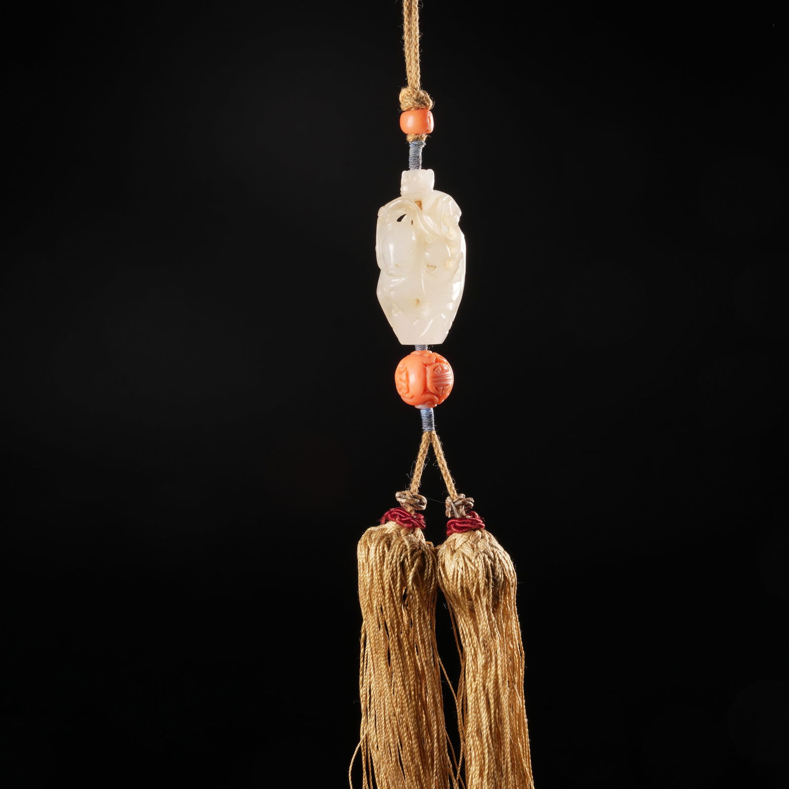 A HETIAN JADE FAN PENDANT WITH "VICTORY ON HORSEBACK" MOTIF: Hetian jade fan pendant with "Victory on Horseback" motif