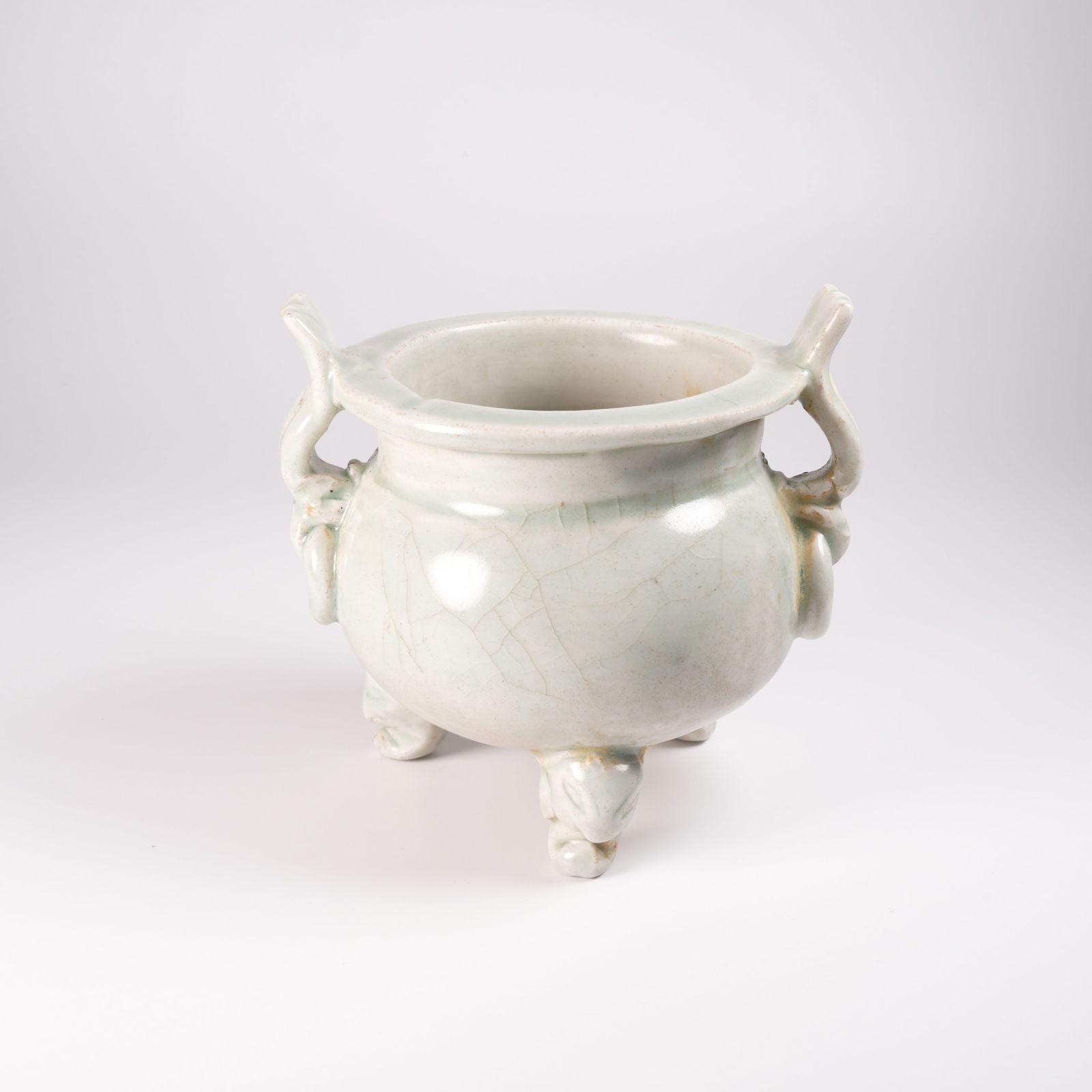 A CIZHOU WHITE-GLAZED TRIPOD FURNACE WITH EARED FUSHOU: Cizhou White-Glazed Tripod Furnace with Eared Fushou