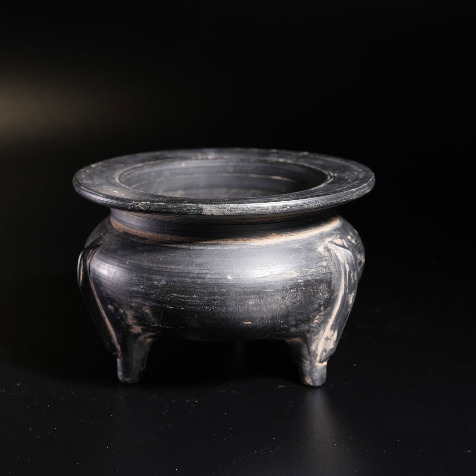 A BLACK POTTERY TRIPOD INCENSE BURNER: Black Pottery Tripod Incense Burner