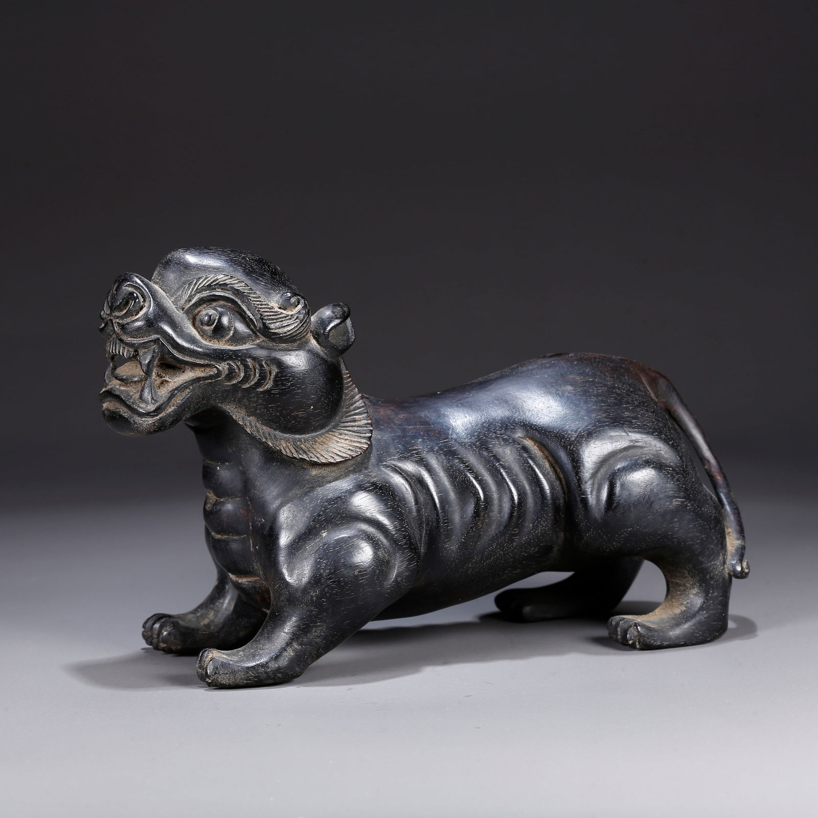 A ZITAN WOOD CARVING OF A BEAST-SHAPED ORNAMENT: Zitan wood carving of a beast-shaped ornament