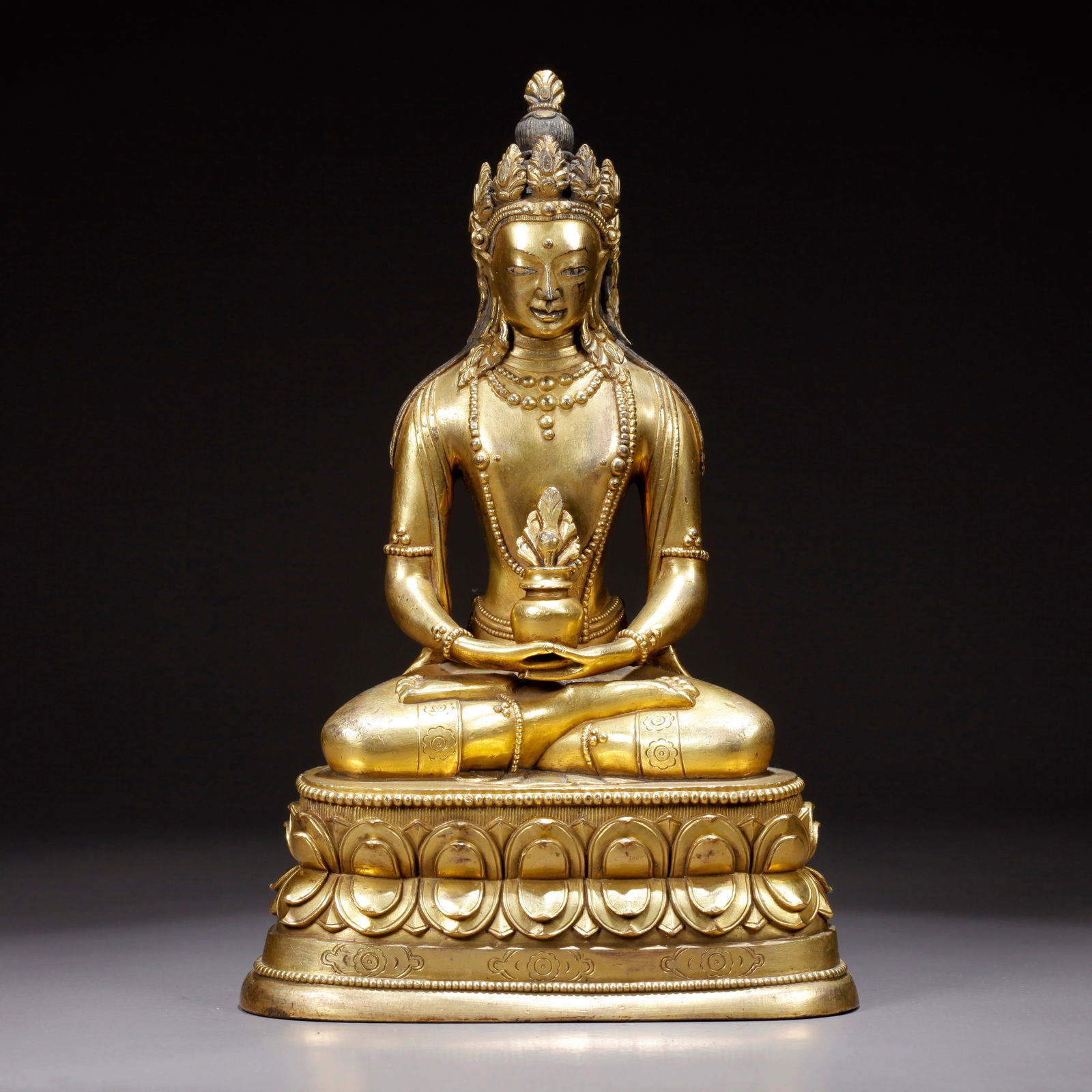 A GILDED BRONZE MEDICINE BUDDHA STATUE: Gilded Bronze Medicine Buddha Statue