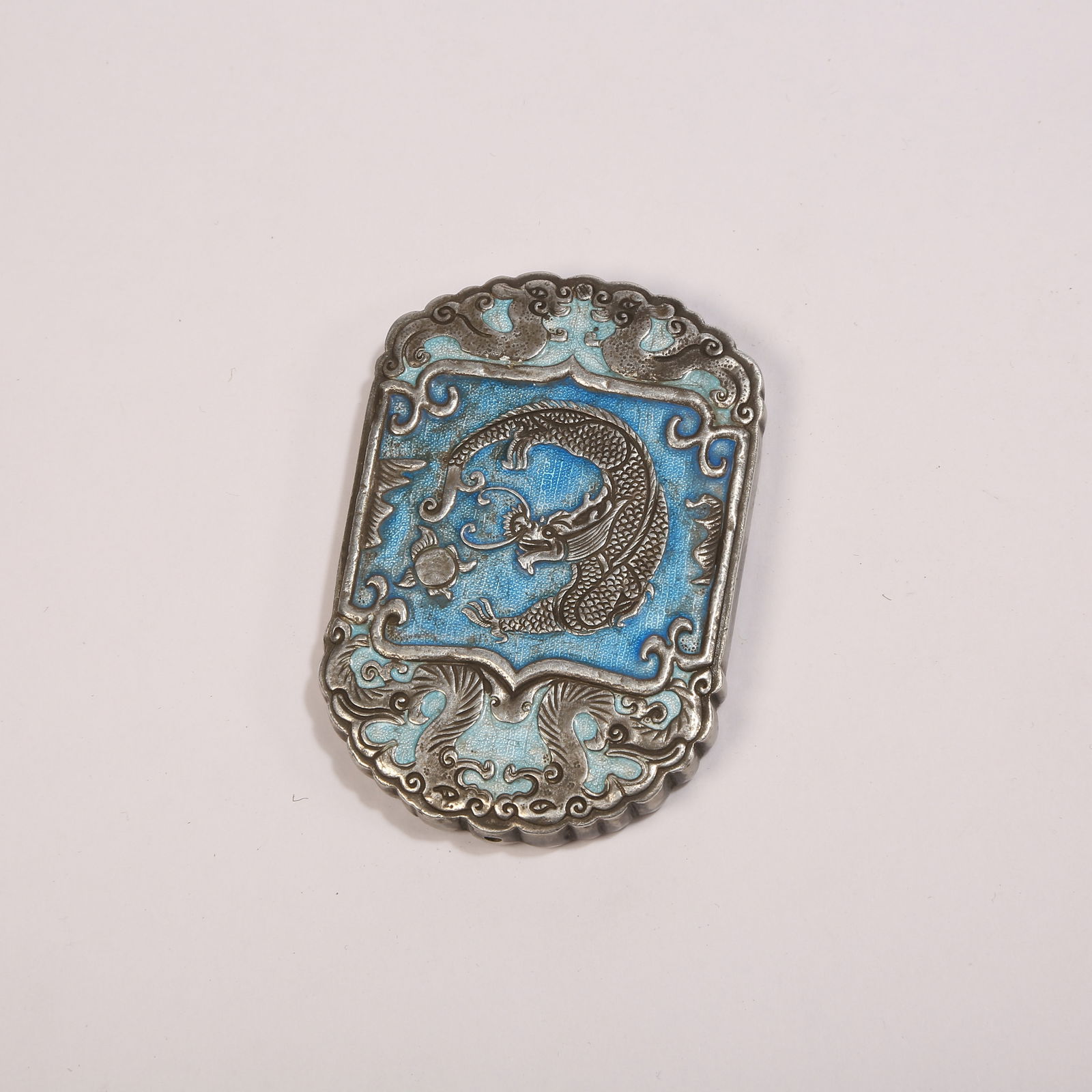 A SILVER SHAOLAN PLAQUE WITH FISH-TO-DRAGON MOTIF: Silver shaolan plaque with fish-to-dragon motif