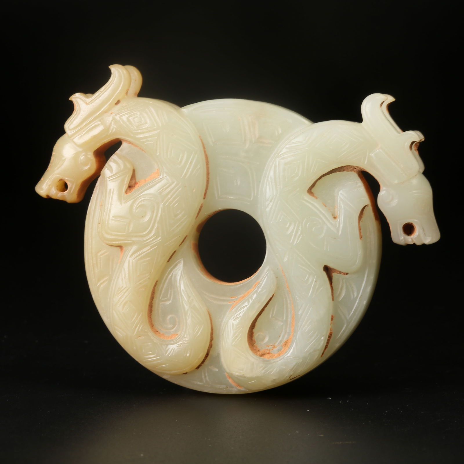 A ARCHAIC JADE BI DISC WITH TWIN-DRAGON MOTIF AND RAISED BORDER: Archaic Jade Bi Disc with Twin-Dragon Motif and Raised Border