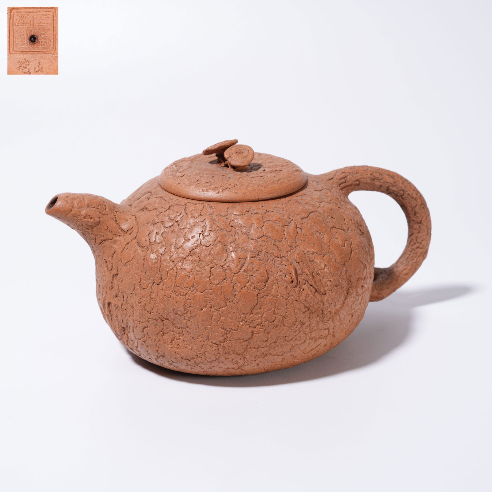 A PURPLE SAND CARVED TEAPOT WITH LINGZHI FINIAL: Purple Sand Carved Teapot with Lingzhi Finial