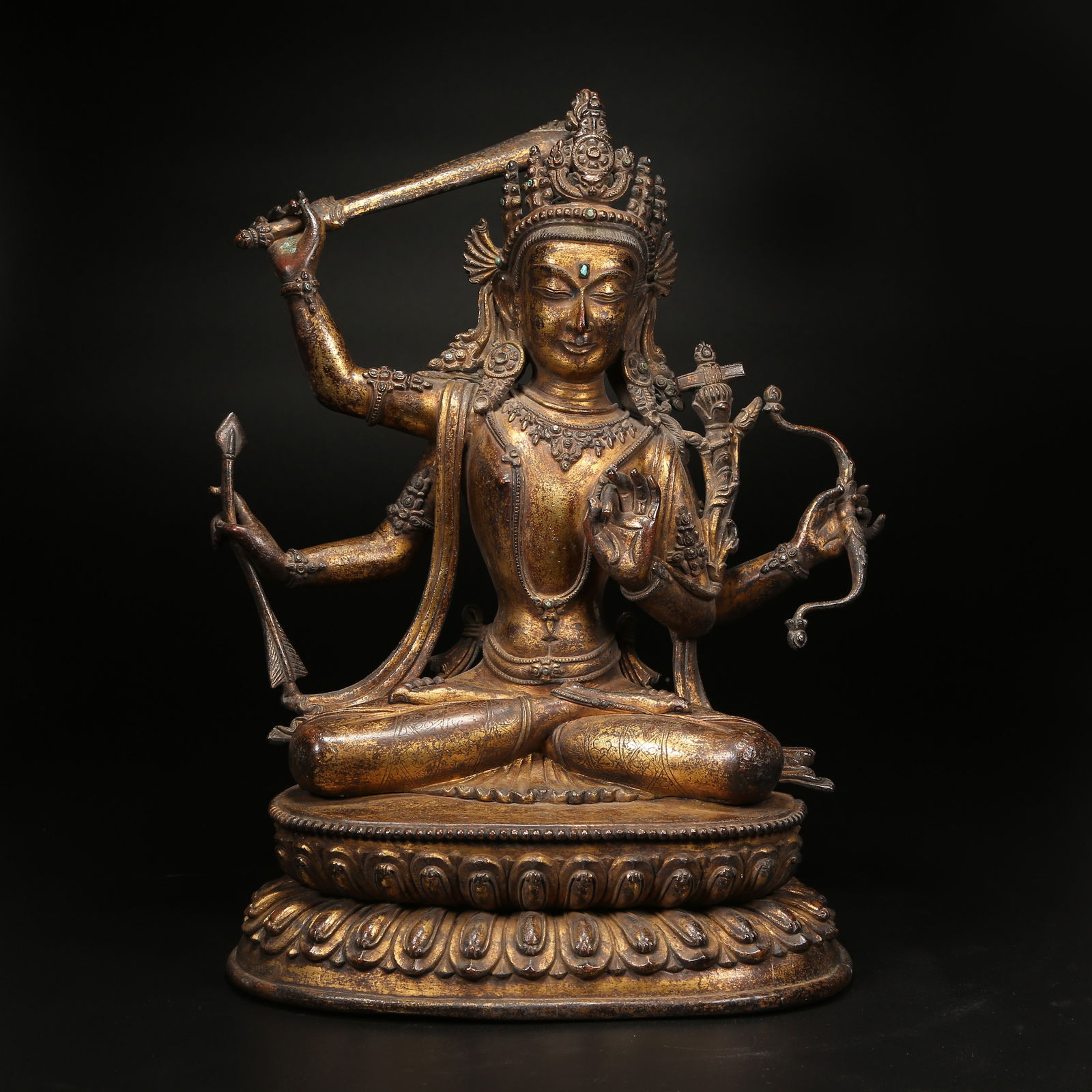 A GILT BRONZE FOUR-ARMED MANJUSHRI BODHISATTVA FIGURE: Gilt Bronze Four-Armed Manjushri Bodhisattva Figure