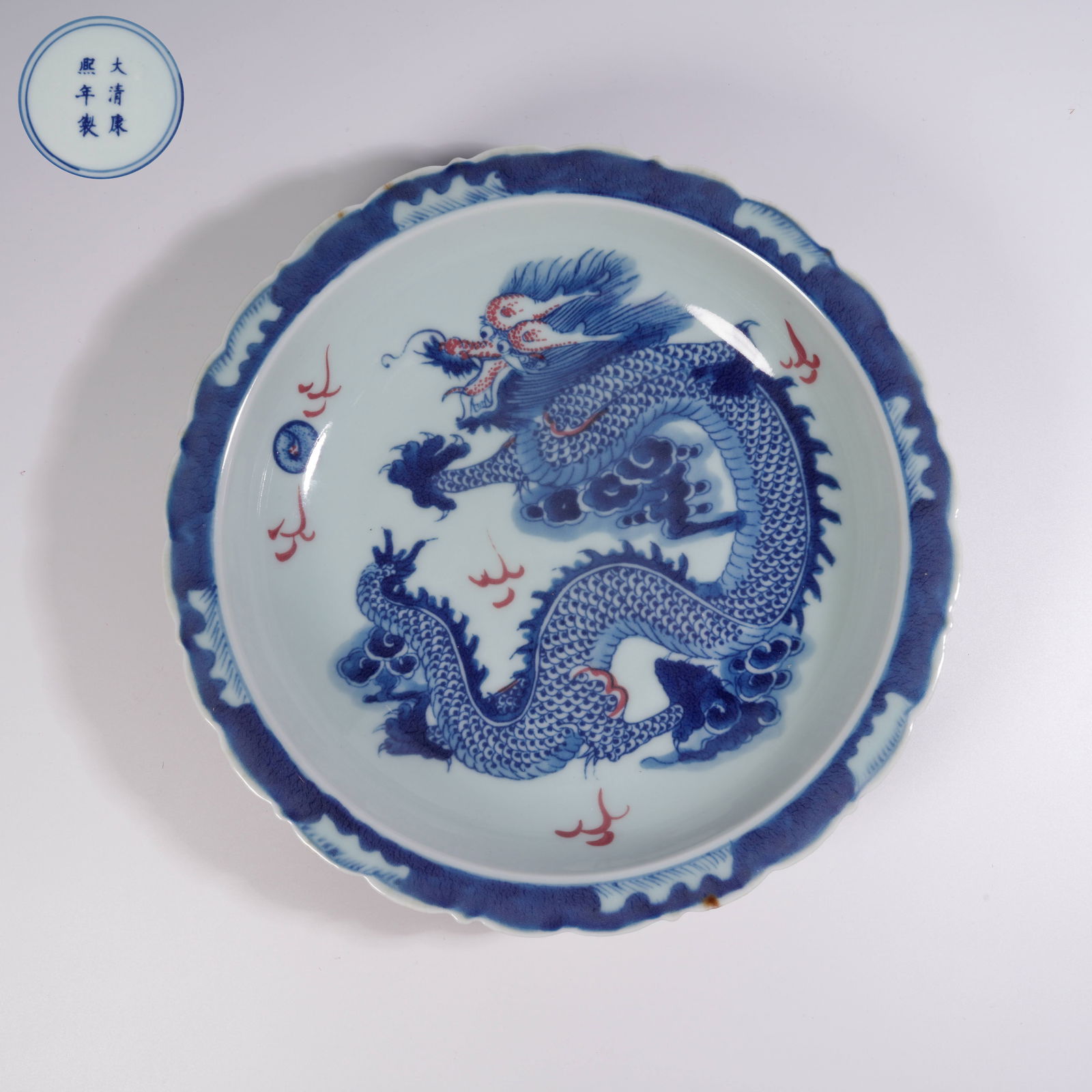 A BLUE-AND-WHITE AND UNDERGLAZE-RED PLATE WITH CLOUD-AND-DRAGON MOTIFS (1 of 7)