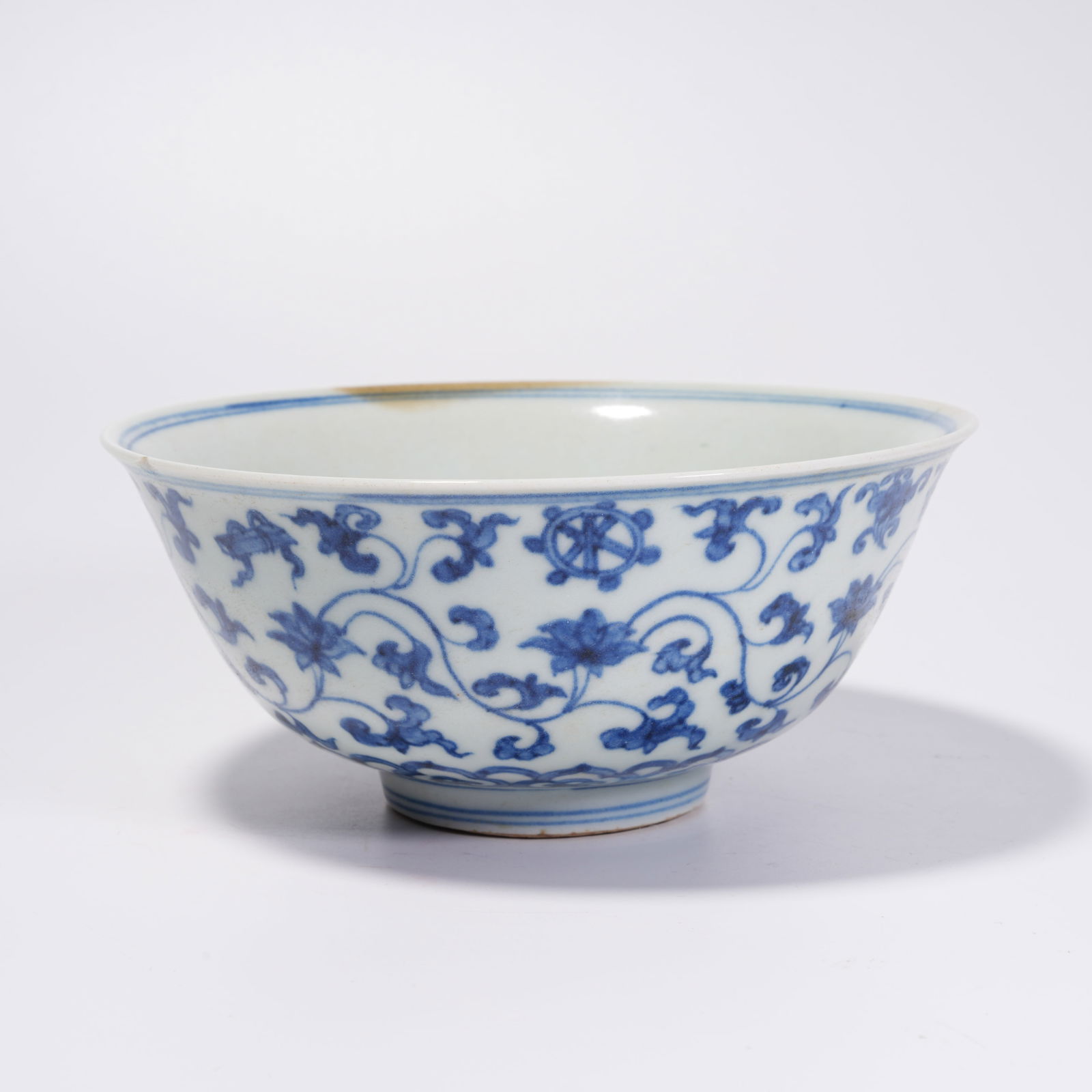 A BLUE-AND-WHITE BOWL WITH CLIMBING FLOWER PATTERN: Blue-and-White Bowl with Climbing Flower Pattern