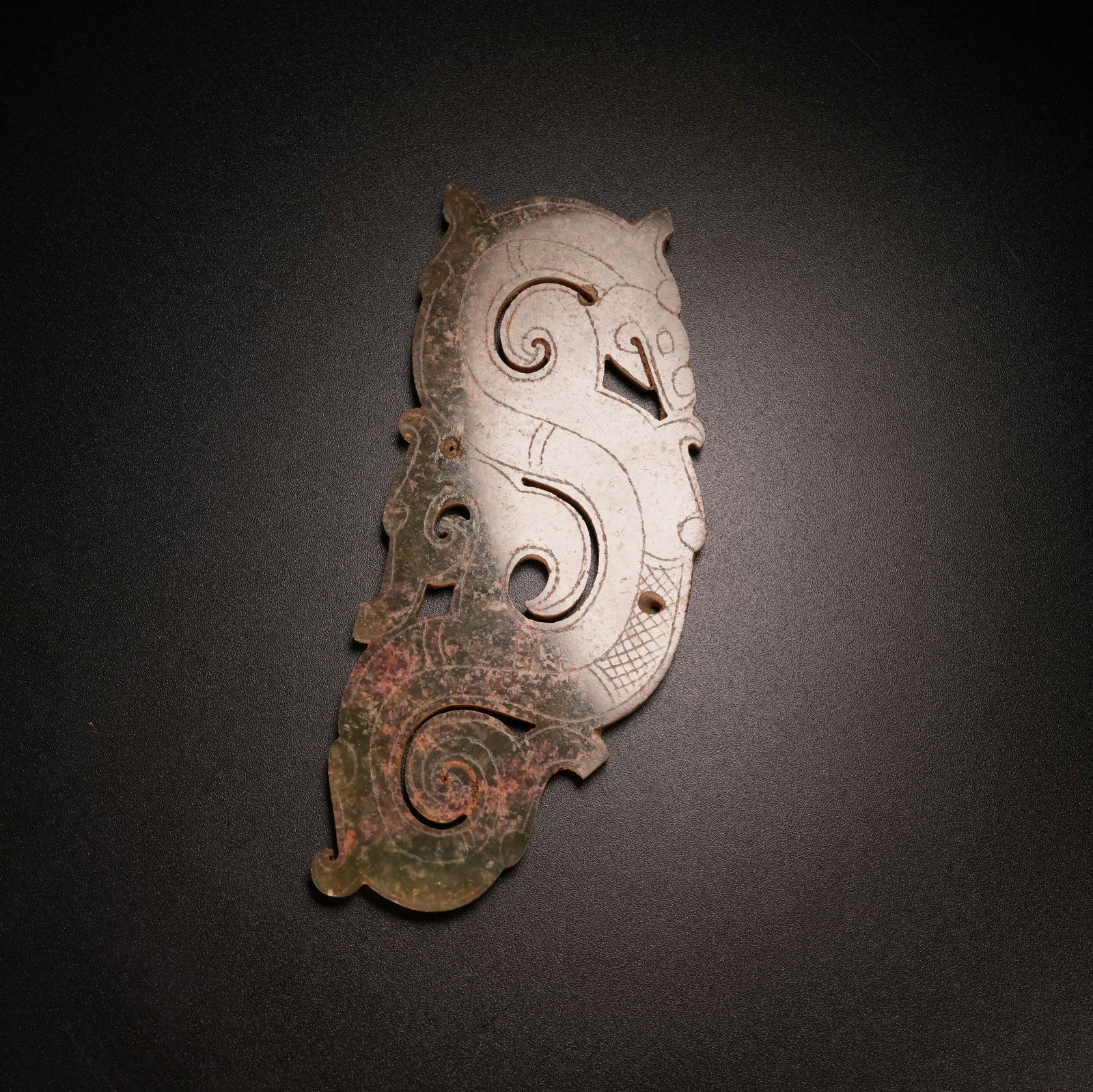 A S-DRAGON PENDANT IN ARCHAIC JADE (1 of 9)