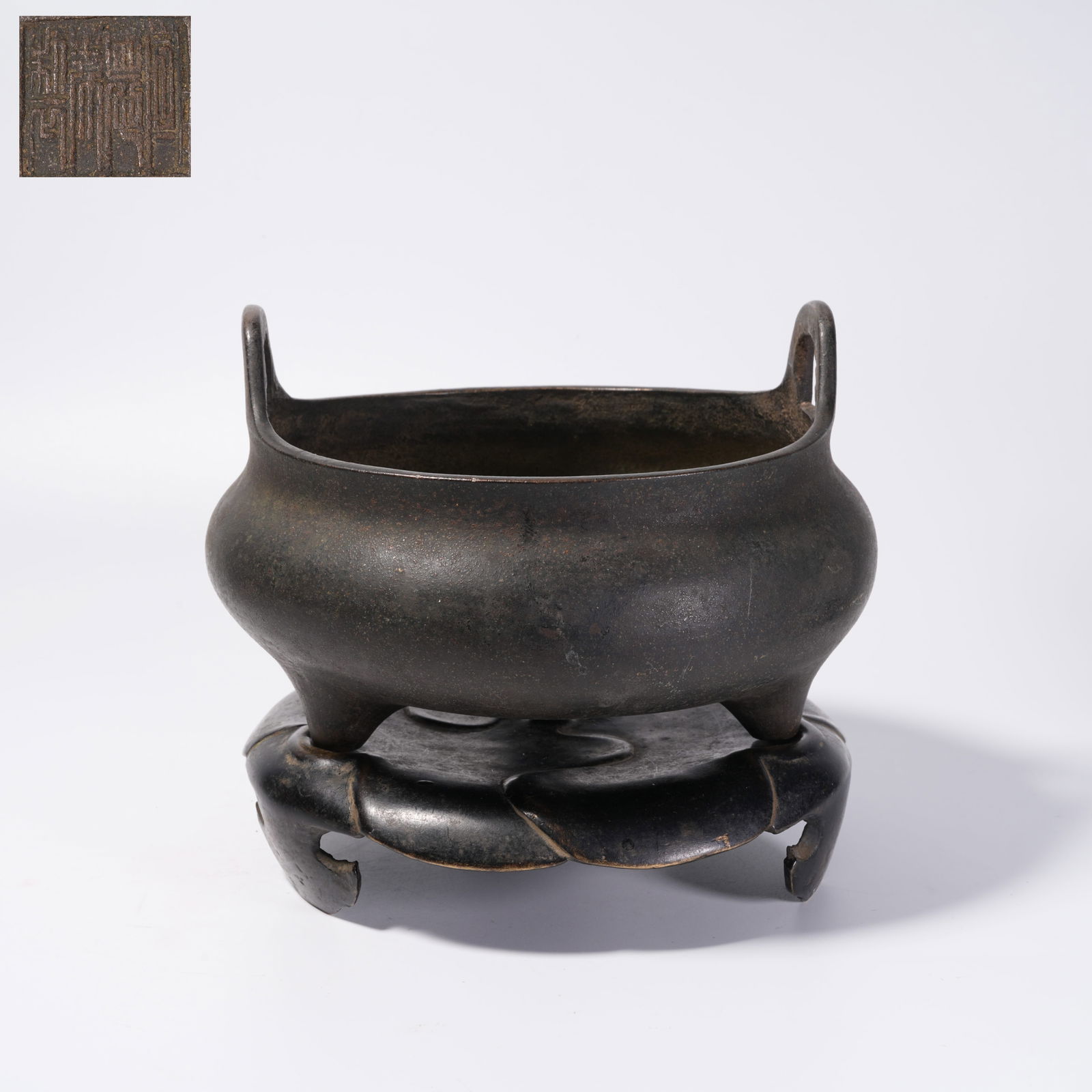 A BRONZE TRIPOD CENSER WITH UPTURNED HANDLES: Bronze Tripod Censer with Upturned Handles